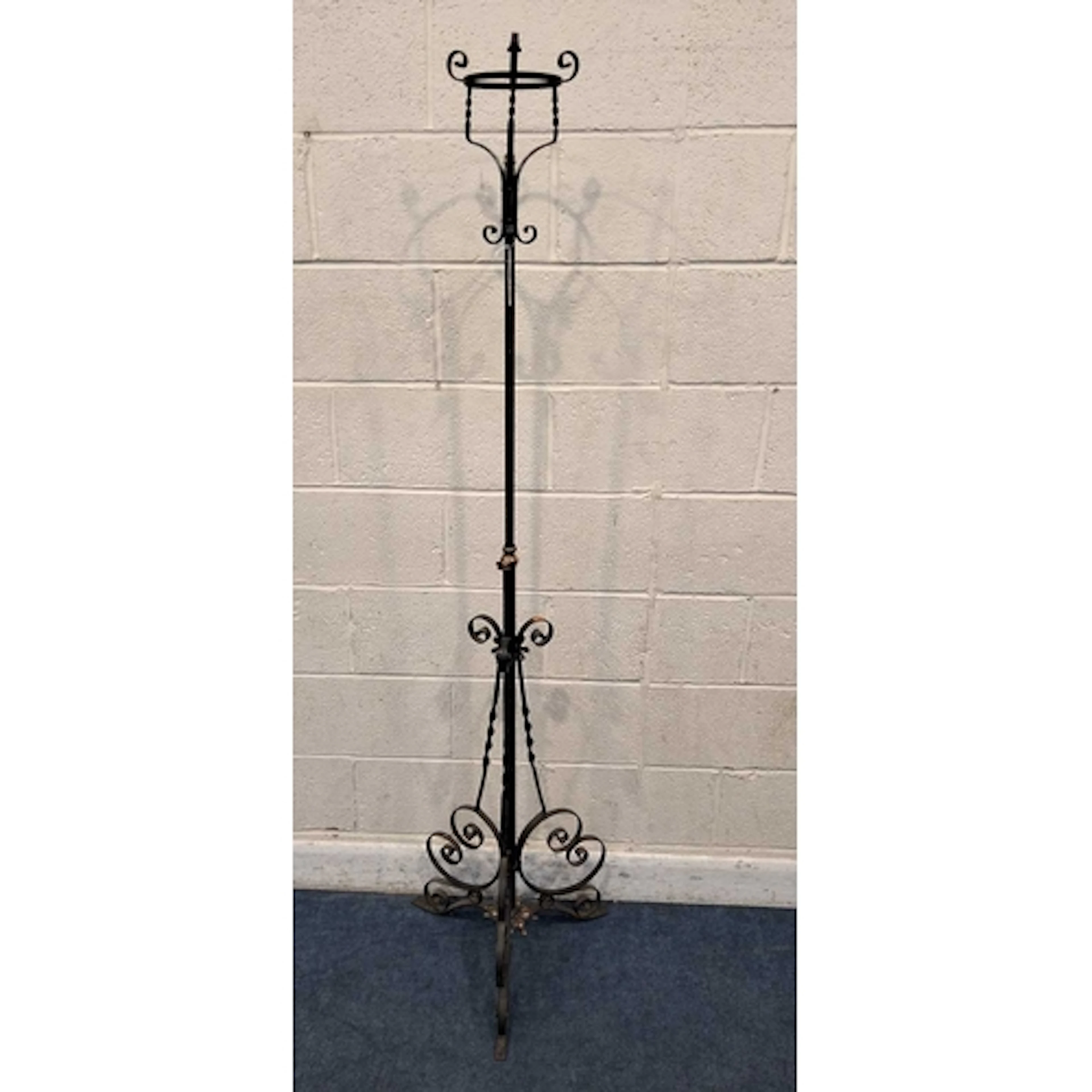 A WROUGHT IRON TELESCOPIC OIL LAMP STAND, with a cradle top,...