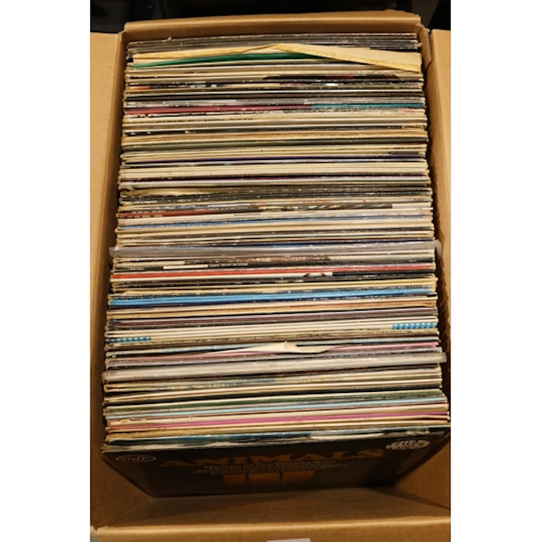 Box containing mixed vinyl records.