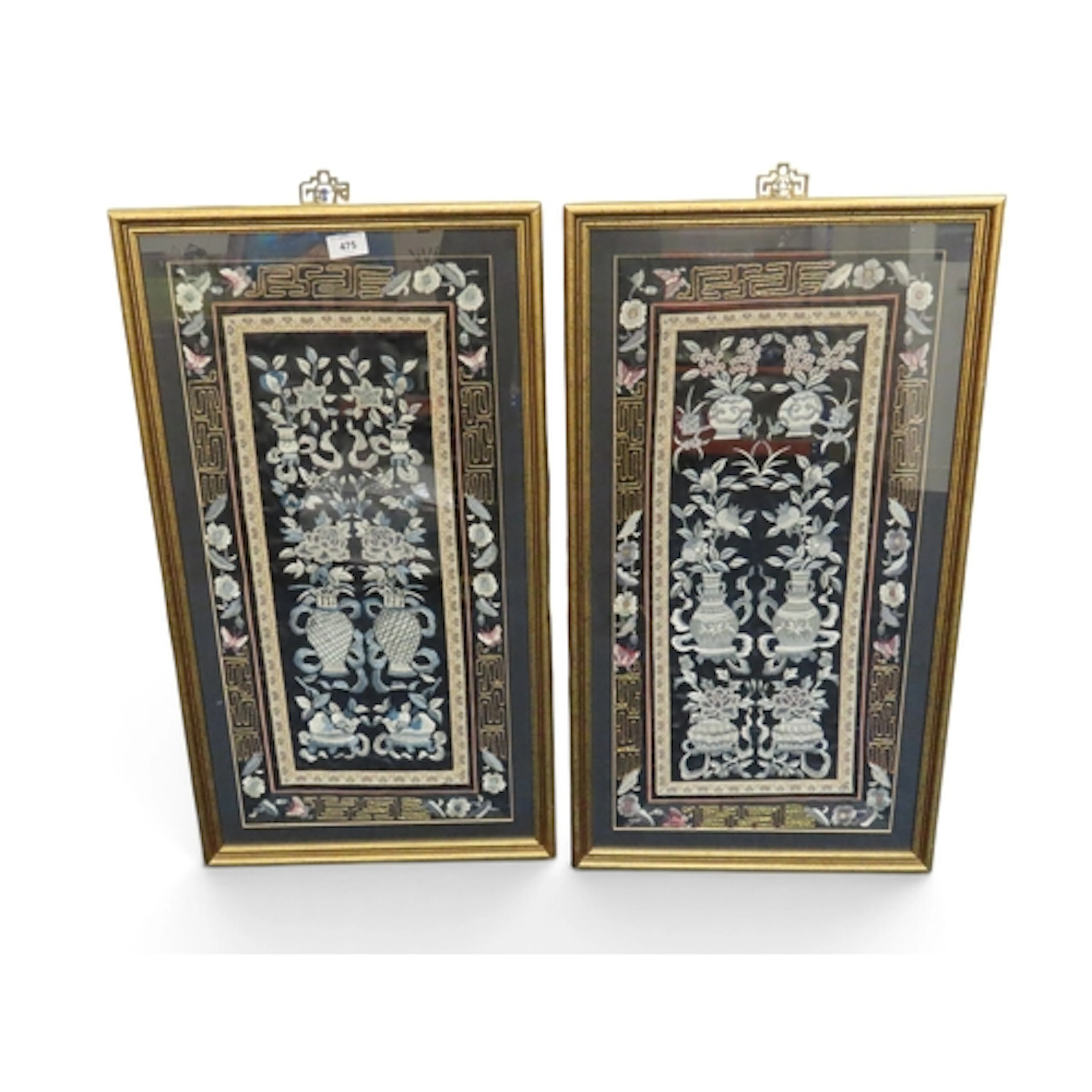 A pair of Chinese silk embroidered panels, decorated with va...