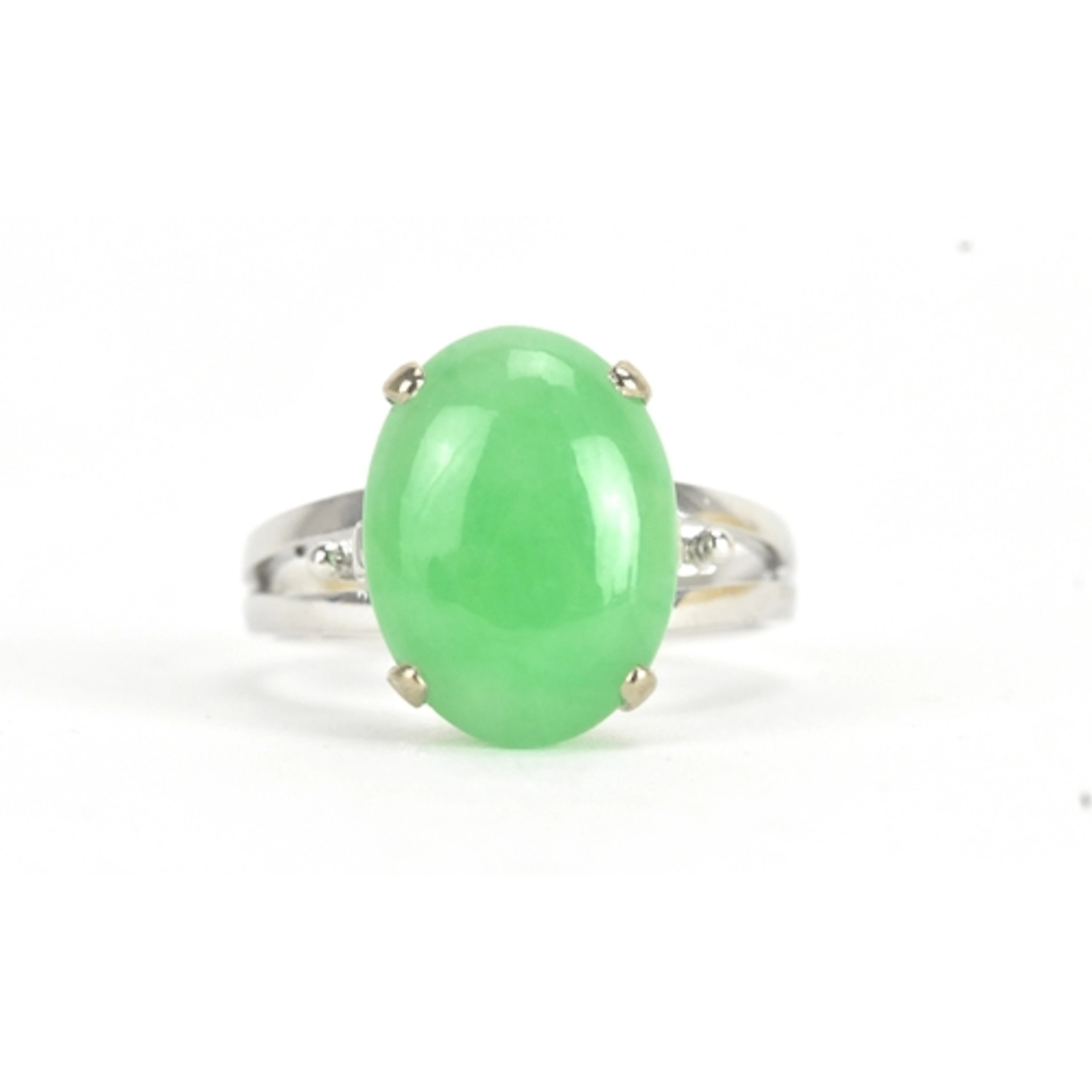 A jade 18ct white gold dress ring, the oval jade cabochon in...