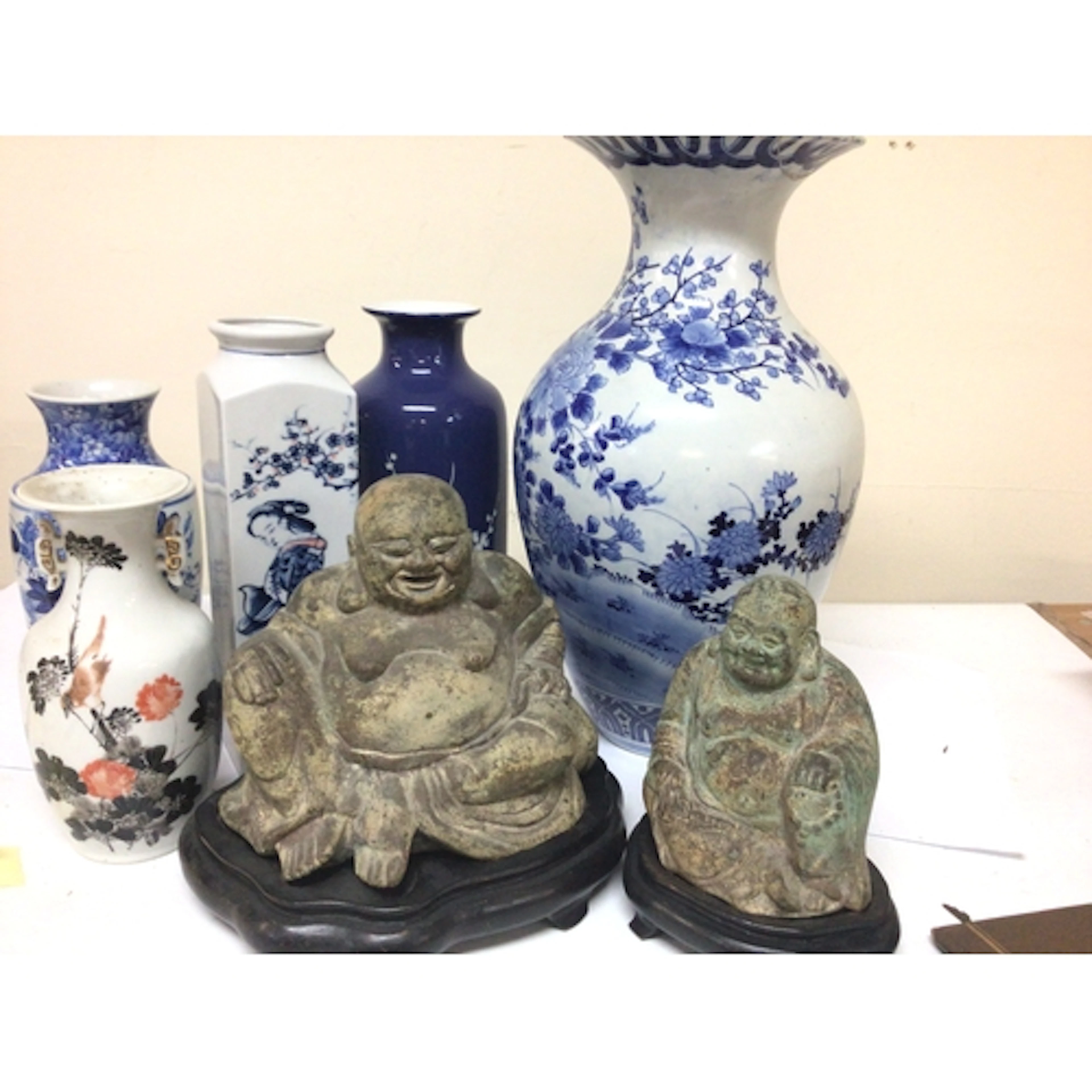 Two cast metal seated figures of buddha on stands and Chines...