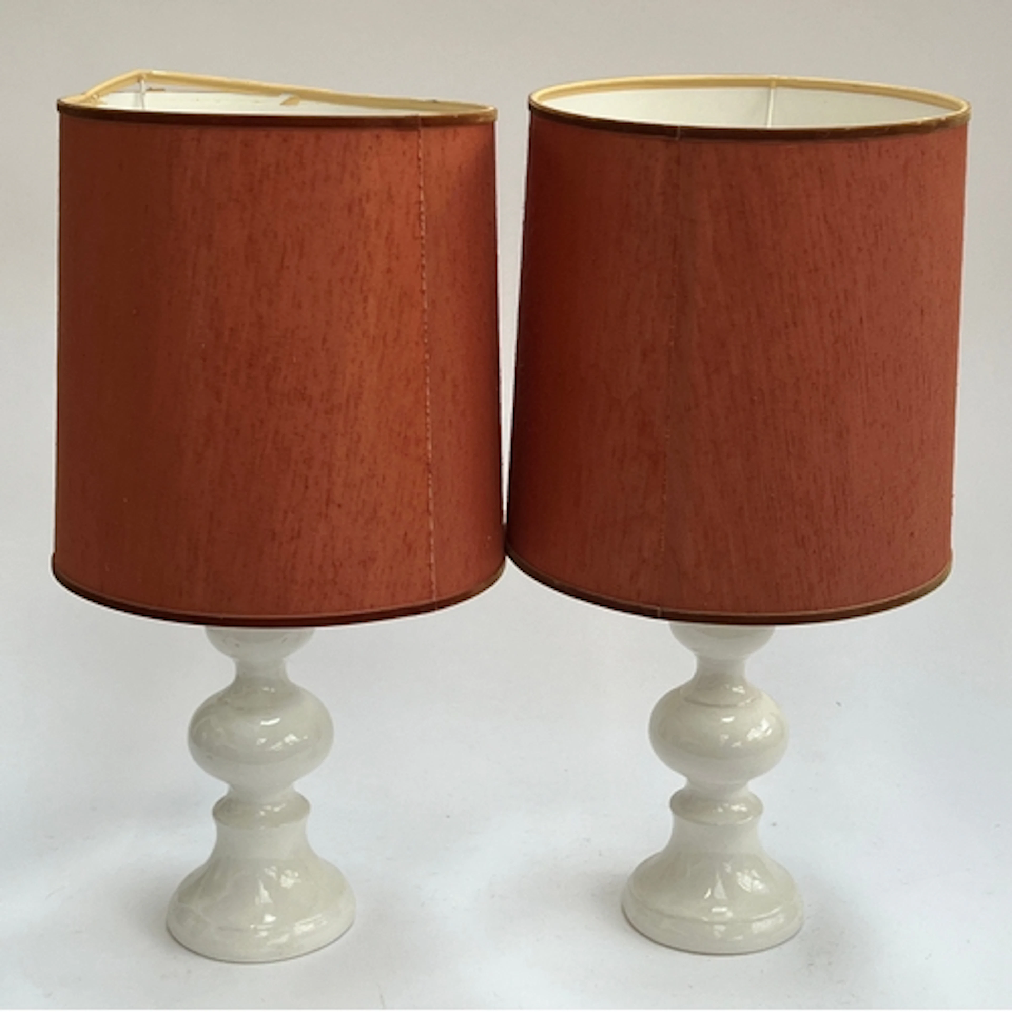 A pair of white porcelain baluster form table lamps with rus...