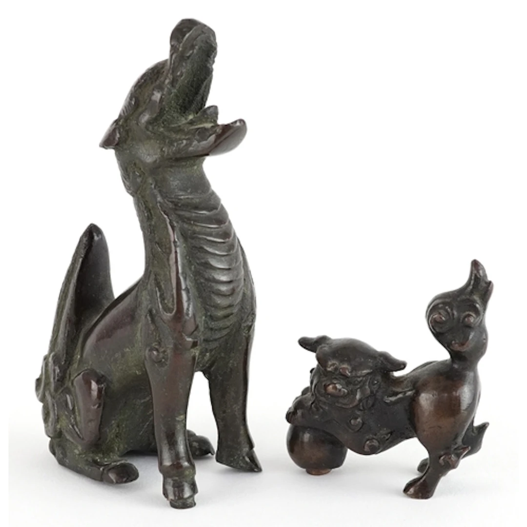 Two Chinese patinated bronze temple dogs, the largest 8.5cm ...