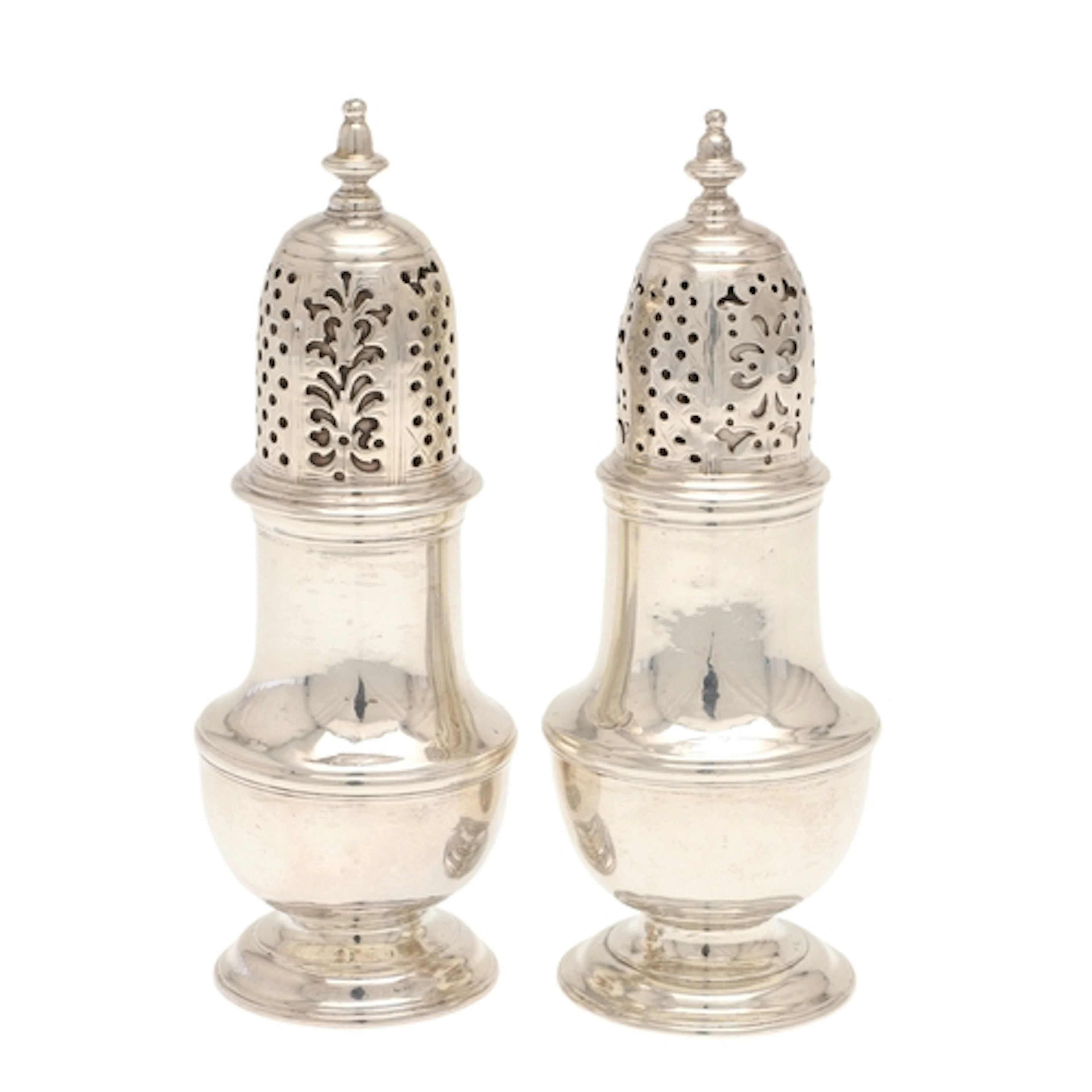 A NEAR PAIR OF GEORGE II SILVER PEPPER CASTERS. Of baluster ...