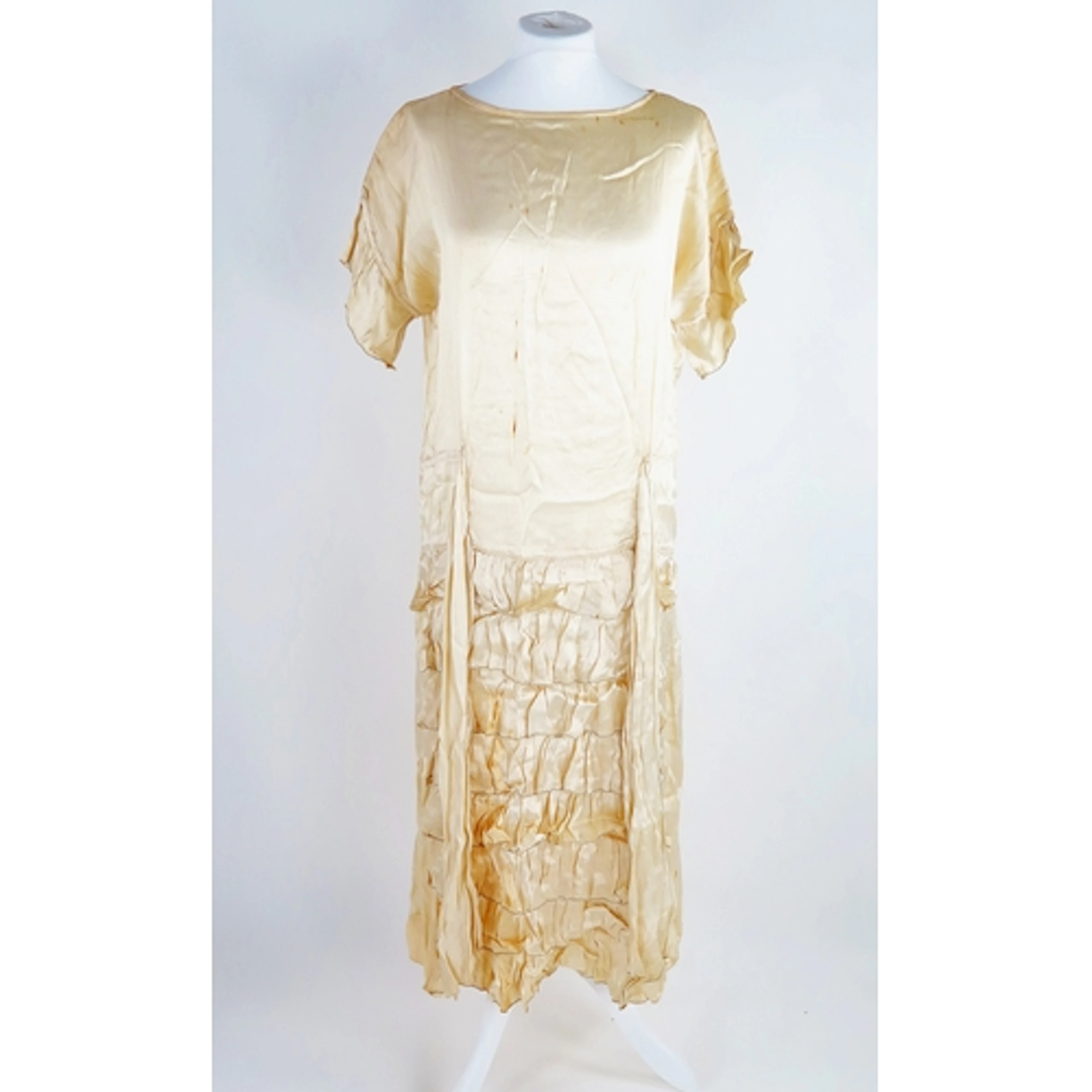 An Art Deco period wedding dress in cream silk, with pleated...