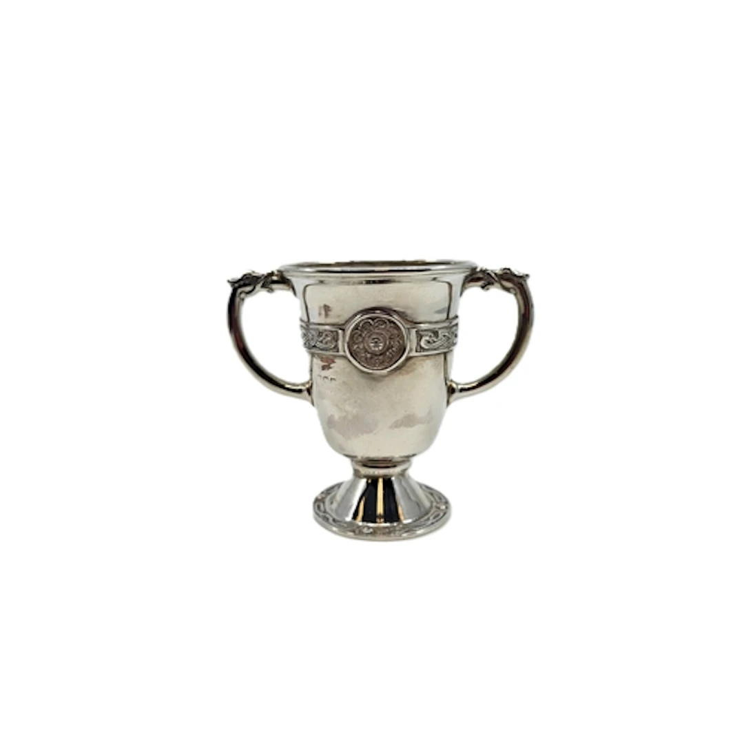 A 1920s TWO HANDLED STERLING SILVER CUP, with Celtic revival...