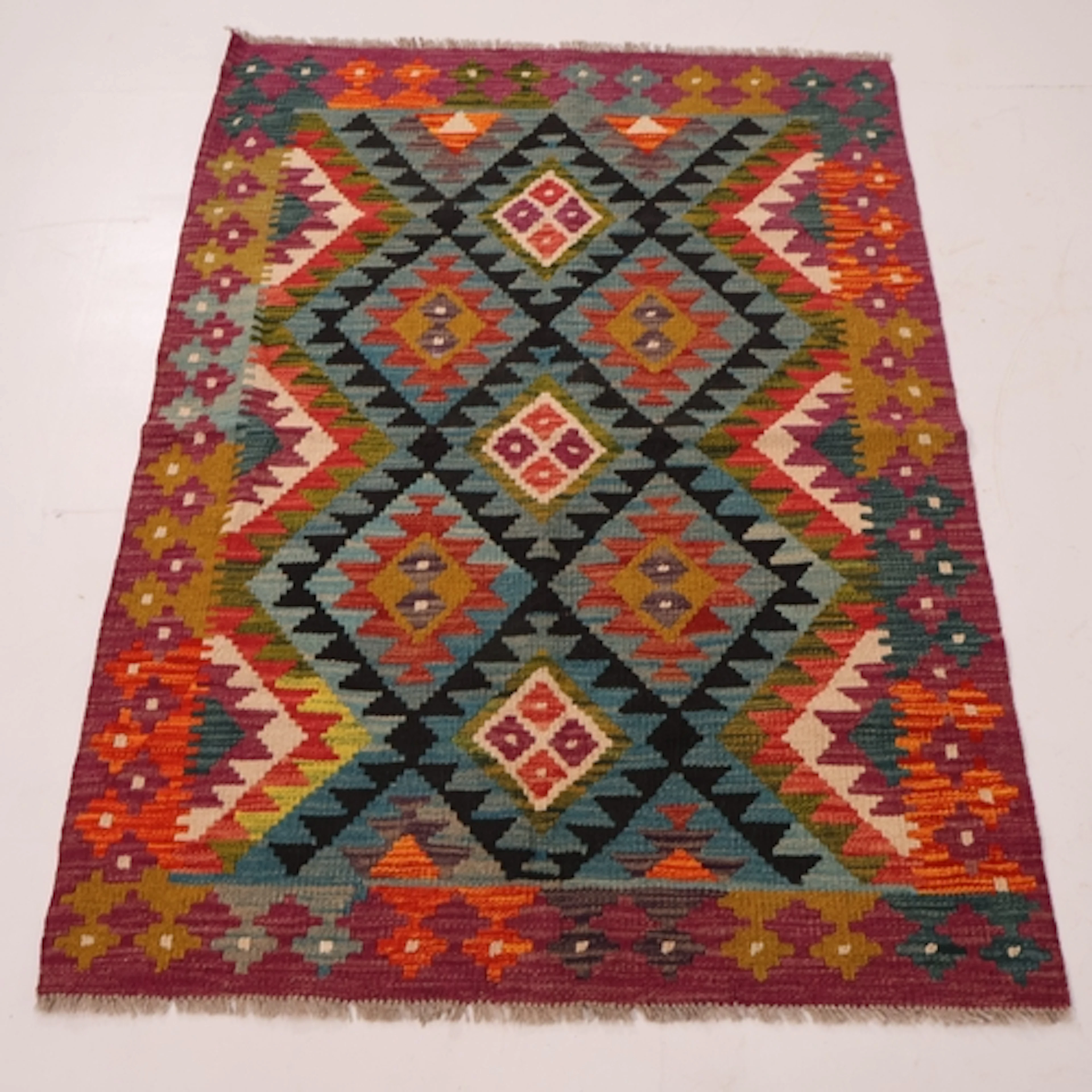 A multi-coloured geometric design maimana kilim rug, L148cm,...