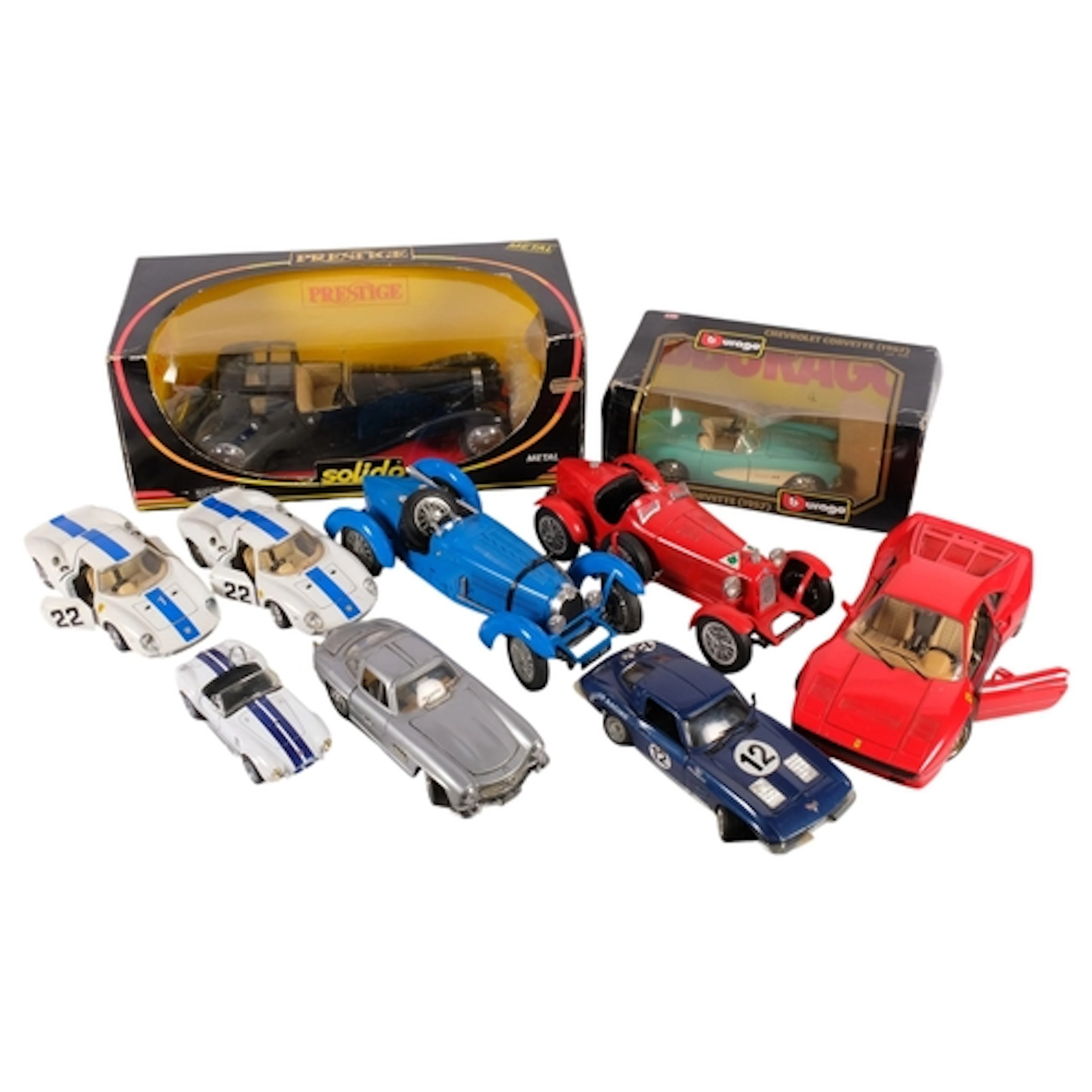 A collection of various diecast model racing cars, including...