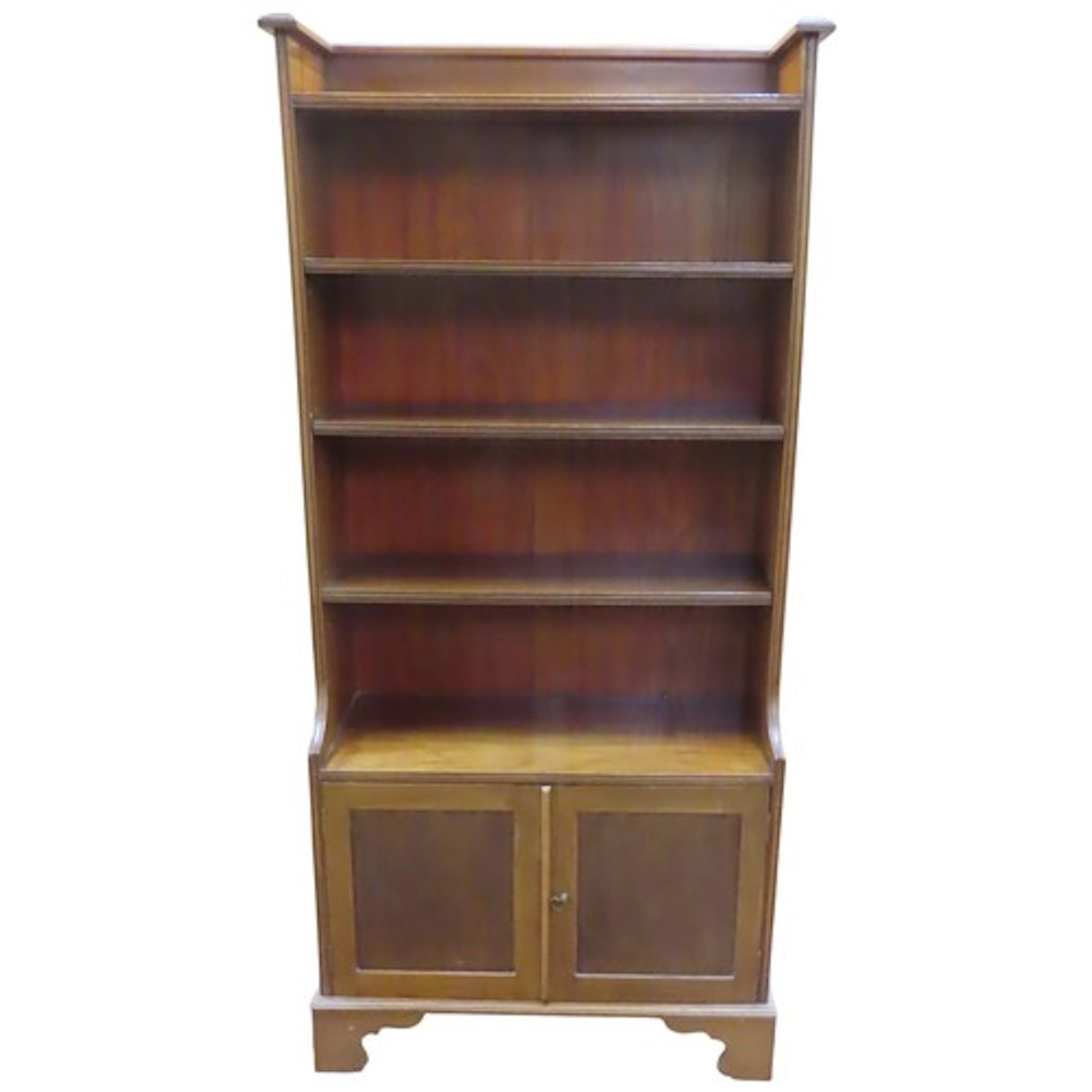 An Arts & Crafts open bookcase in mahogany with an enclosed ...