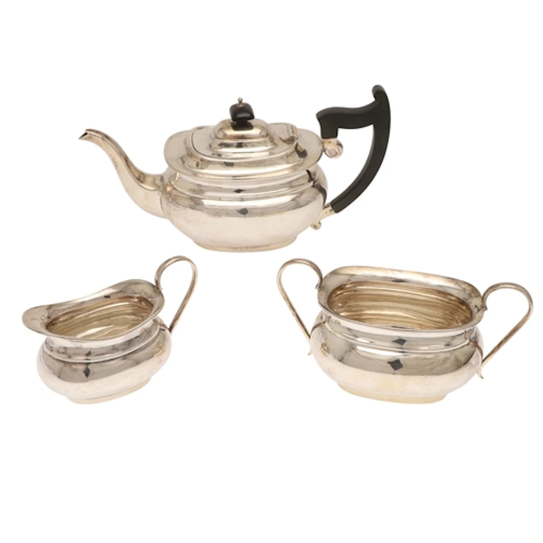 A GEORGE V SILVER THREE PIECE TEASET, BY VINER'S LTD. To inc...