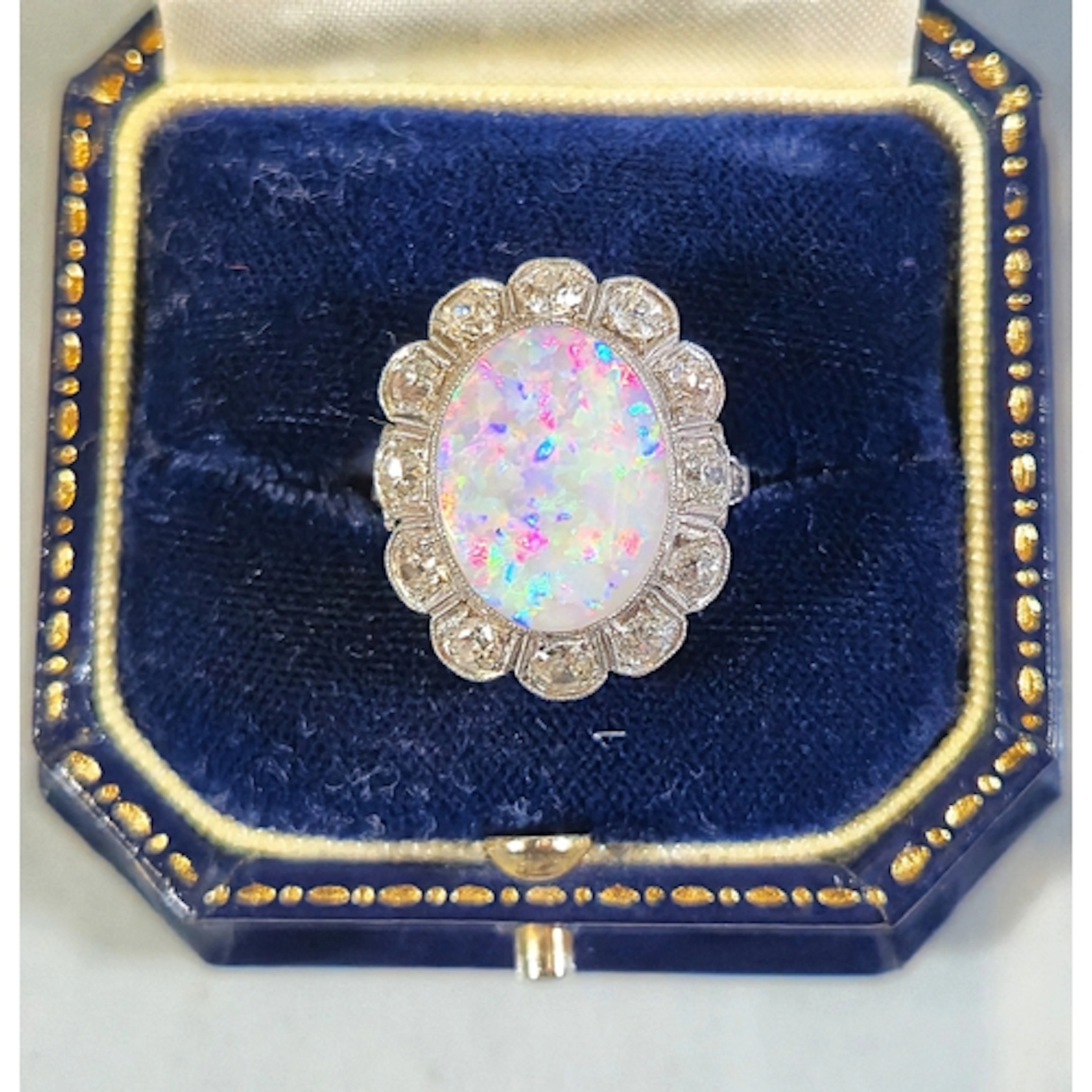 Opal and diamond ladies cluster ring set with a large vibran...