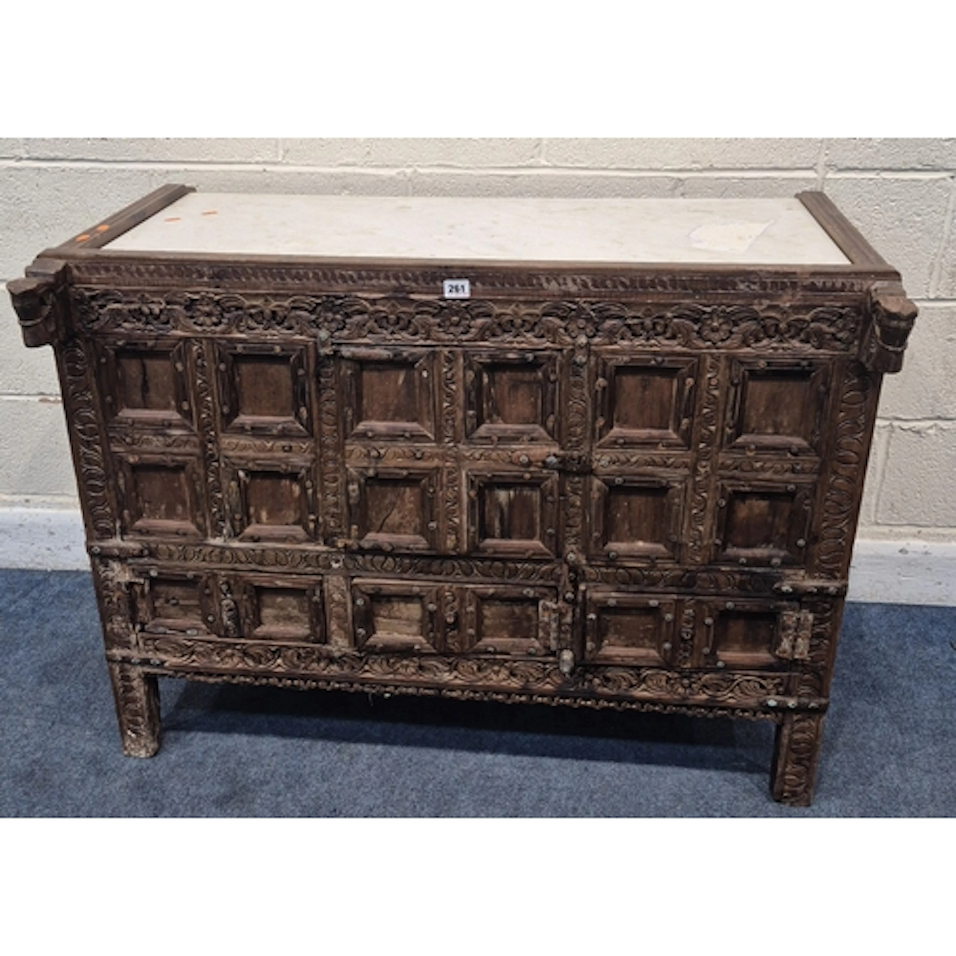 A CARVED INDIAN DOWRY CHEST / DAMCHIYA, with a marble top, r...
