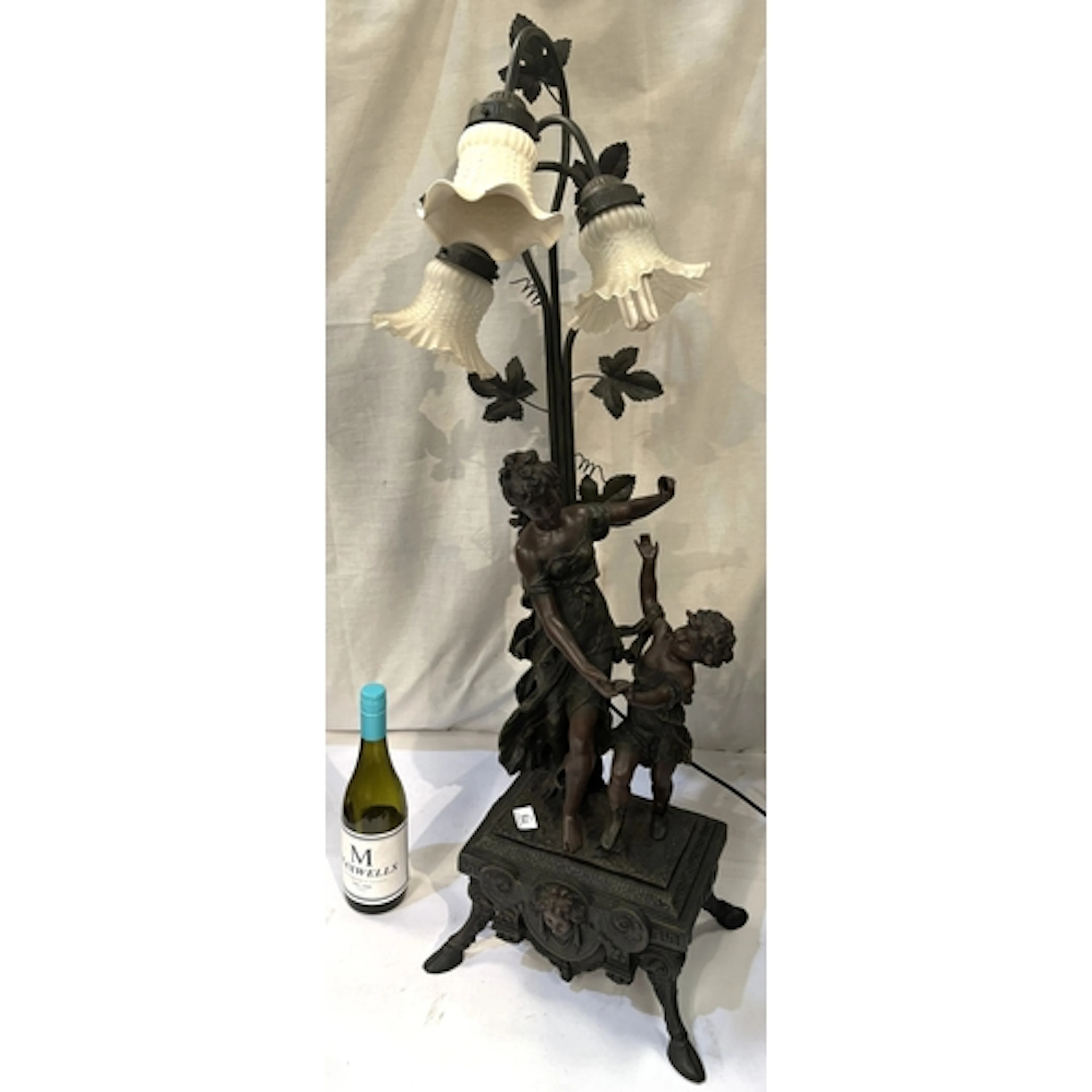 A bronzed 3 branch lamp featuring a lady and child dancing o...