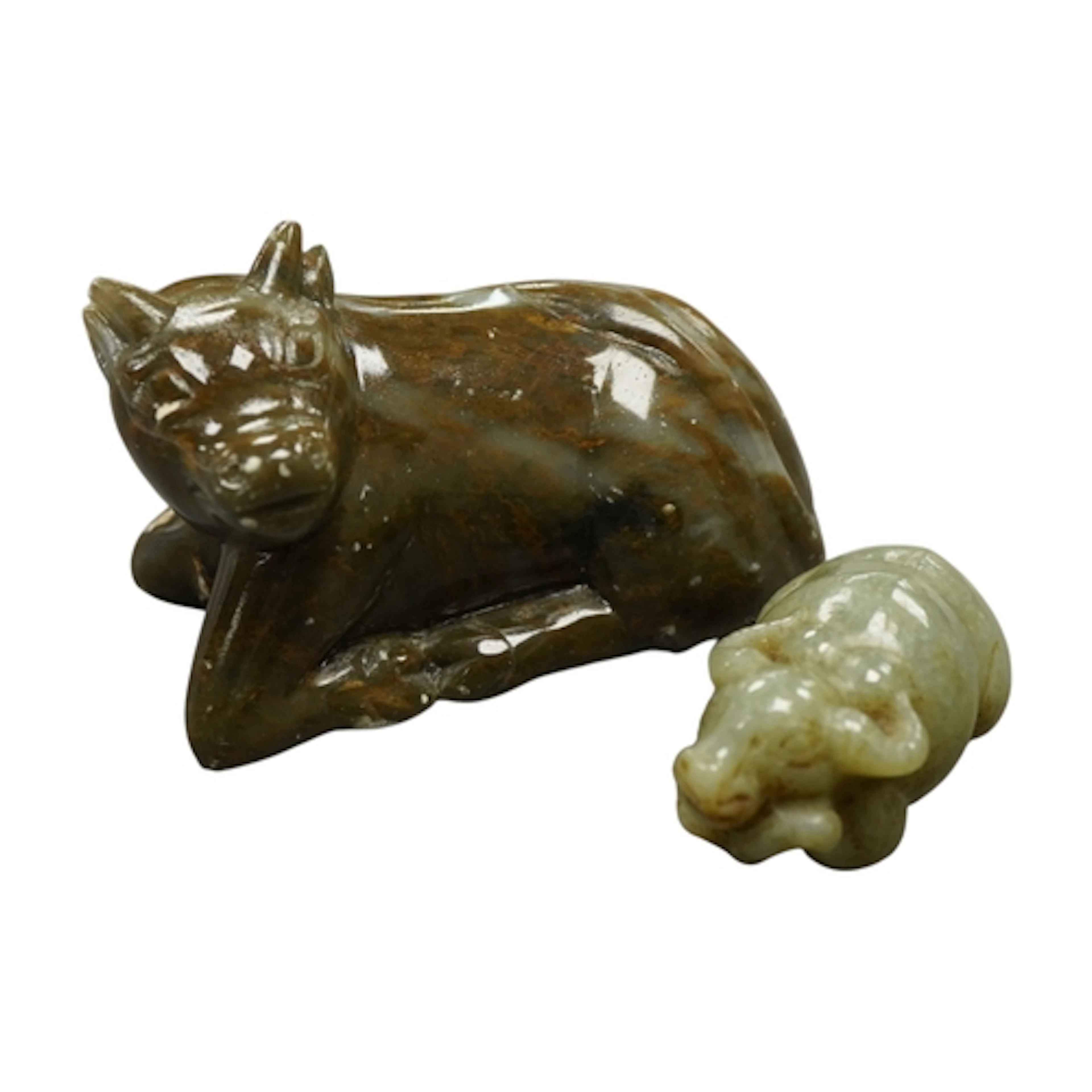 A Chinese green jade buffalo and a soapstone buffalo, larges...