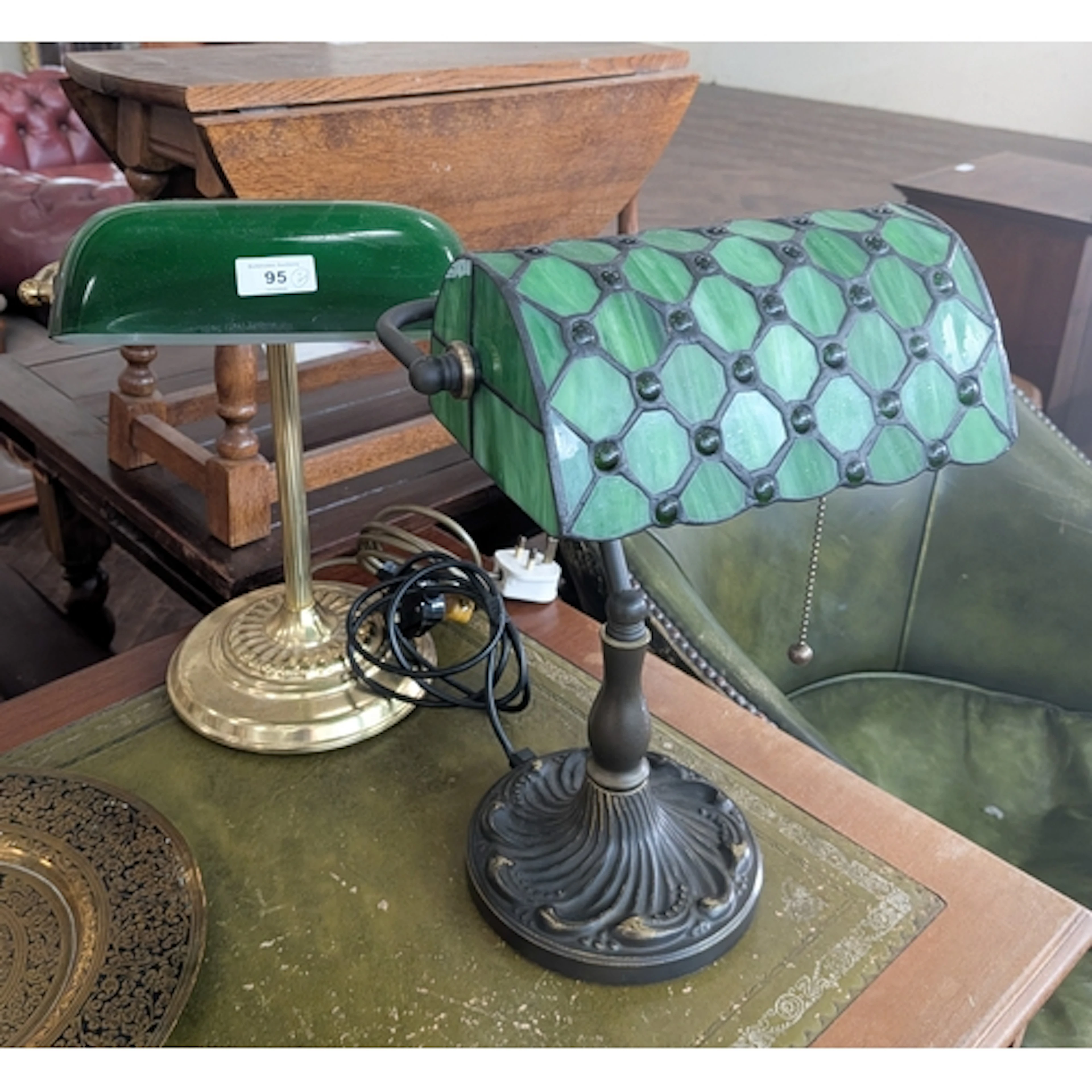 A Liberty style desk lamp and a brass and green glass banker...