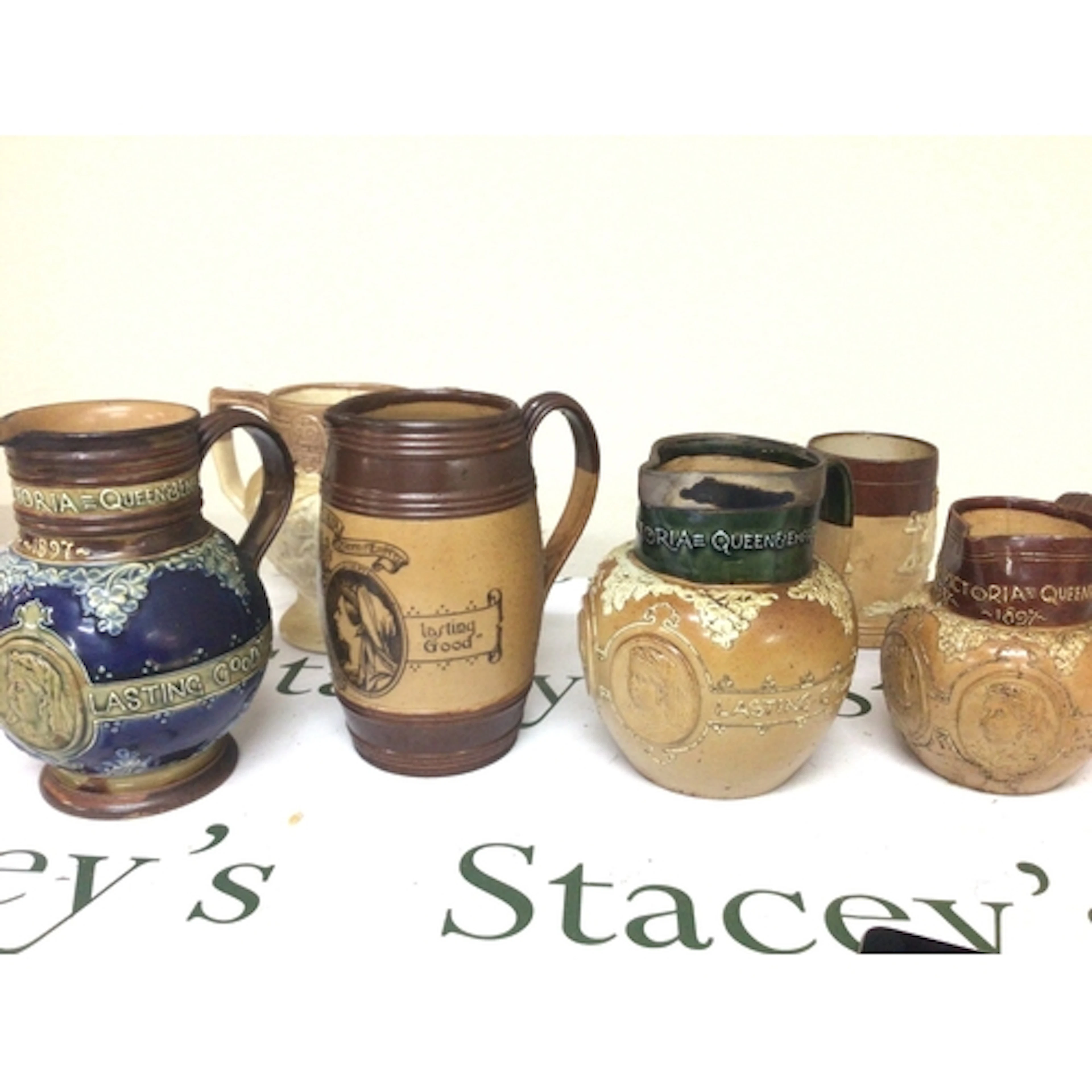 A collection of Doulton stoneware Victorian jugs Jubilee com...