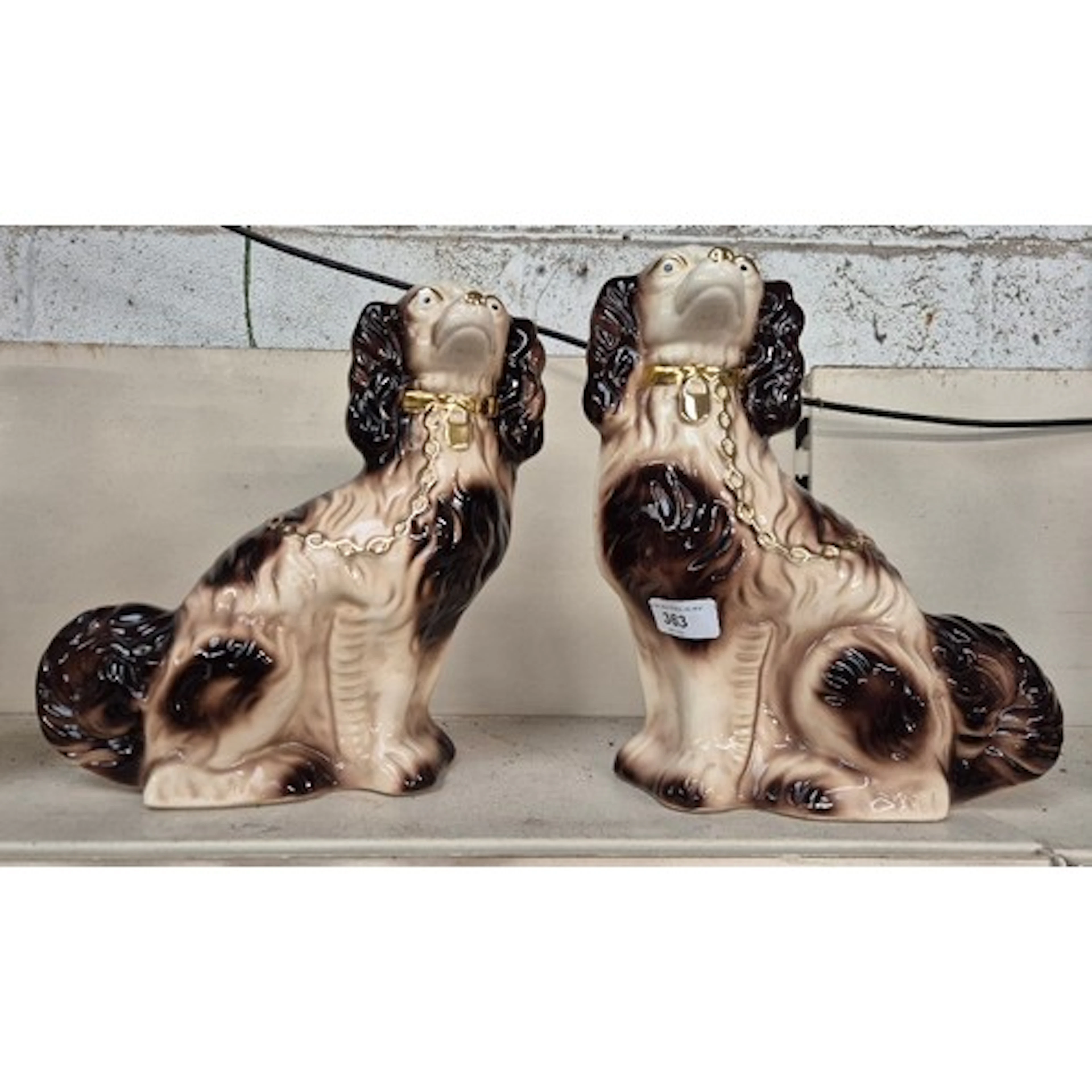 A pair of Staffordshire pottery dogs