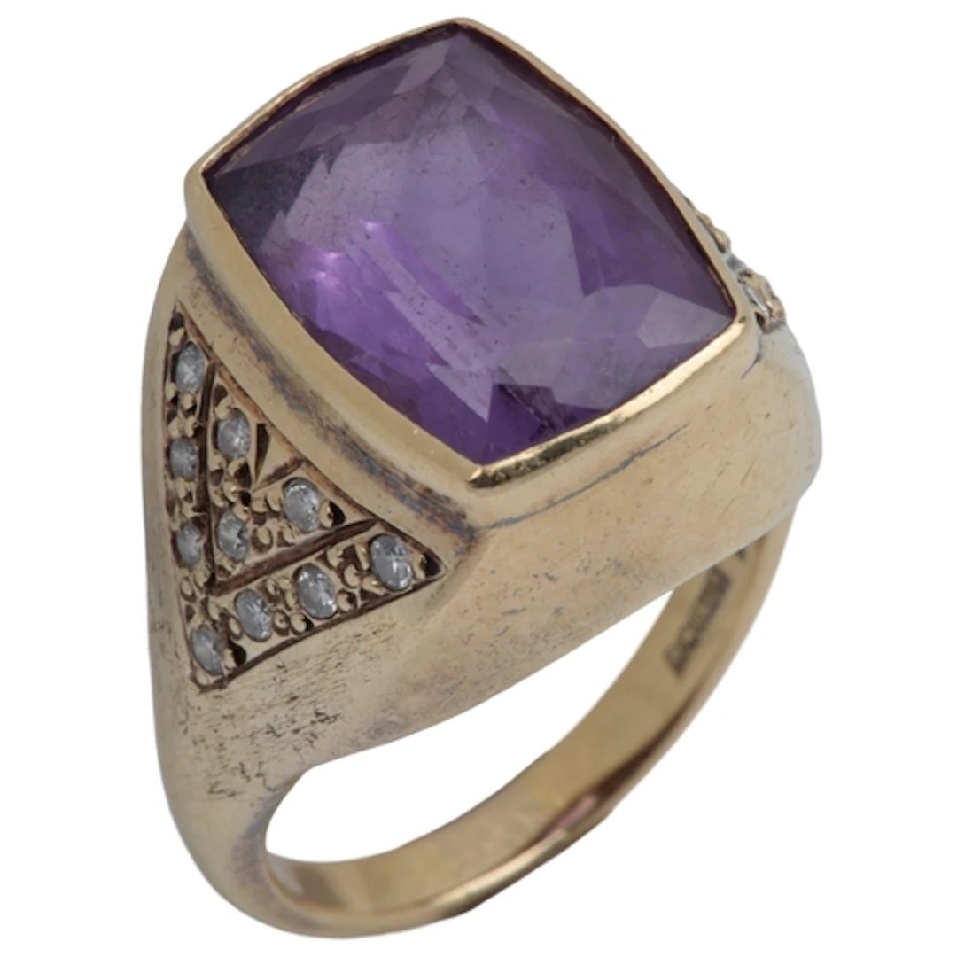 An amethyst and diamond ring, collet-set with an elongated c...