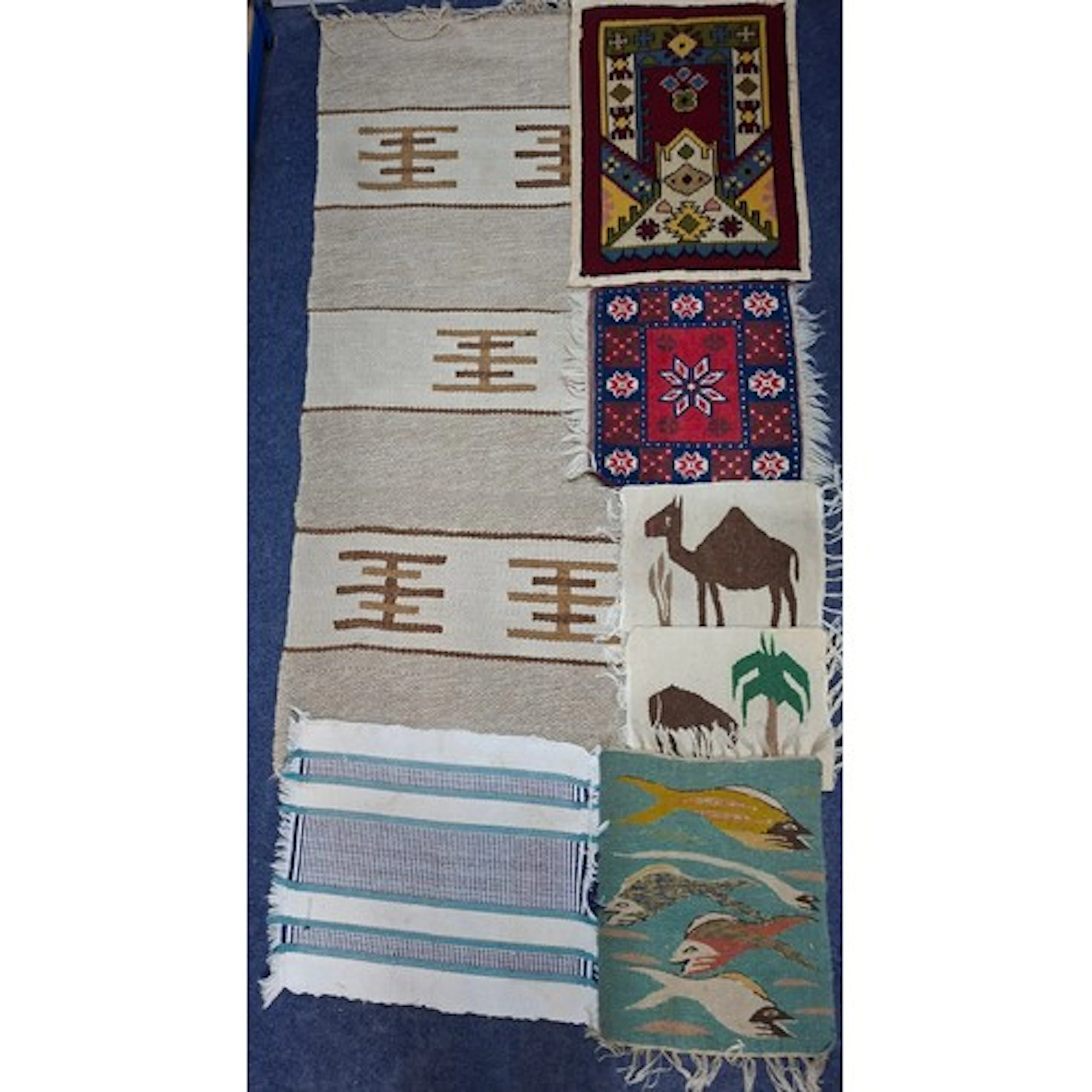 A group of small Worldwide textile rugs to include a Turkish...