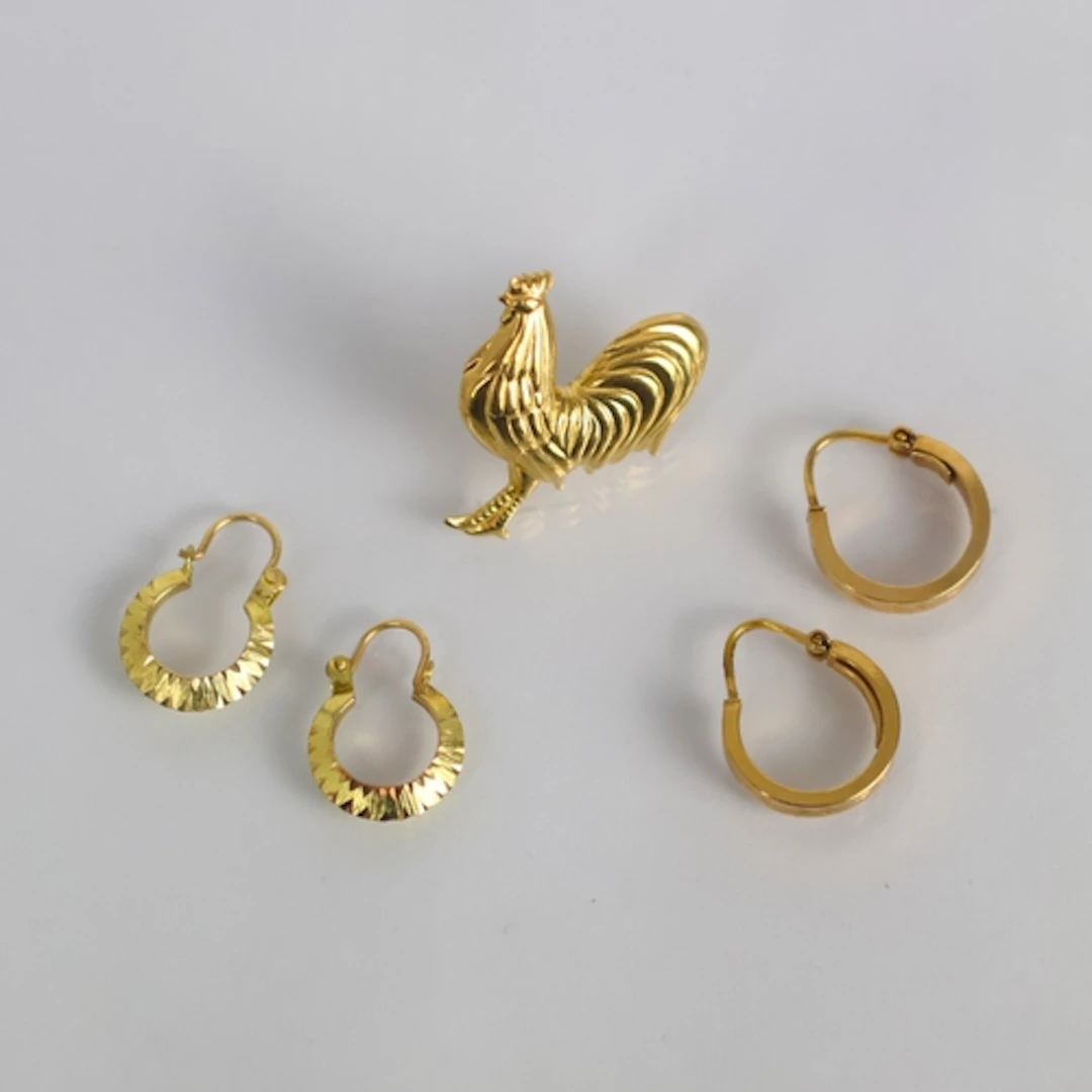 A pair of yellow metal hoop earrings, by Unoaerre, of typica...