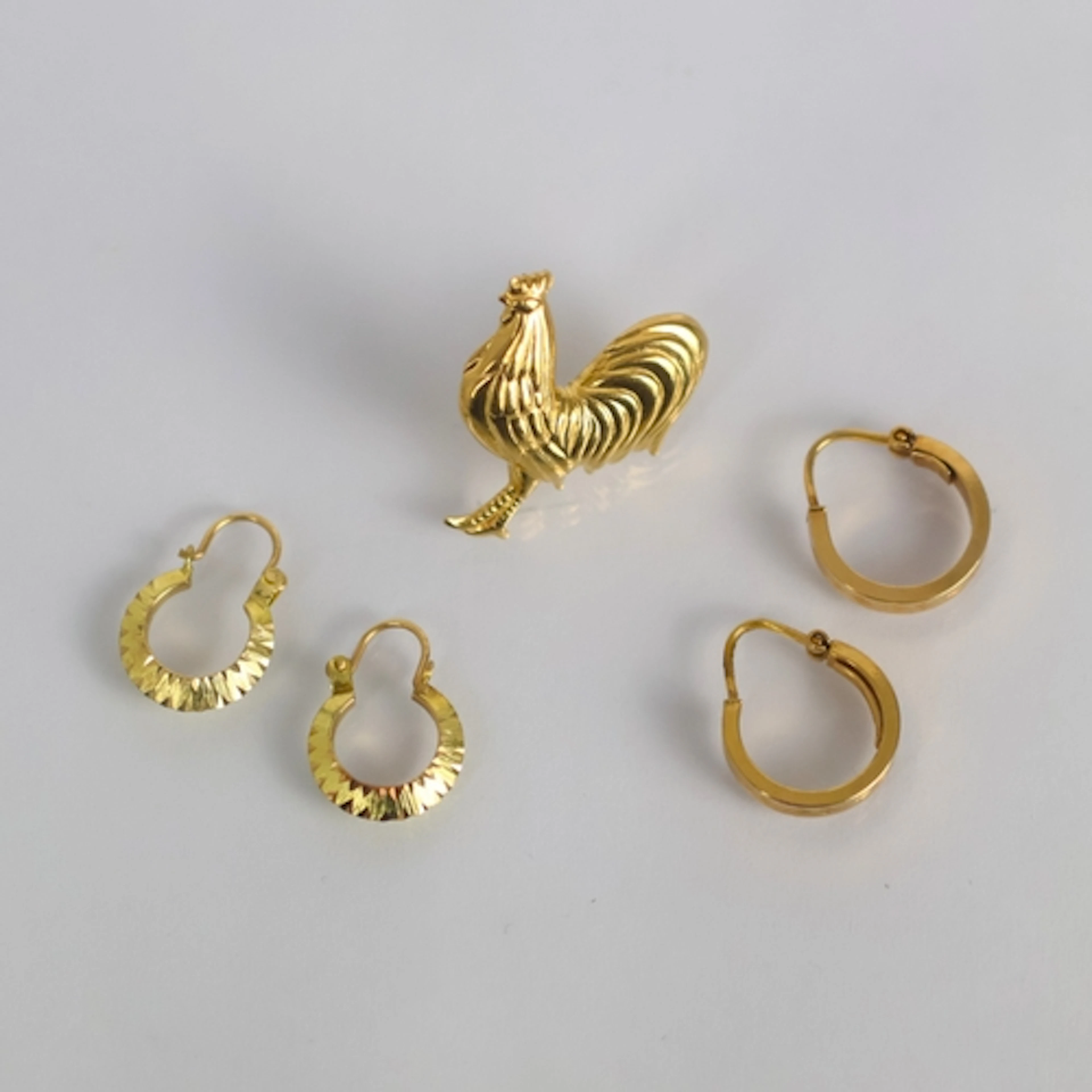 A pair of yellow metal hoop earrings, by Unoaerre, of typica...