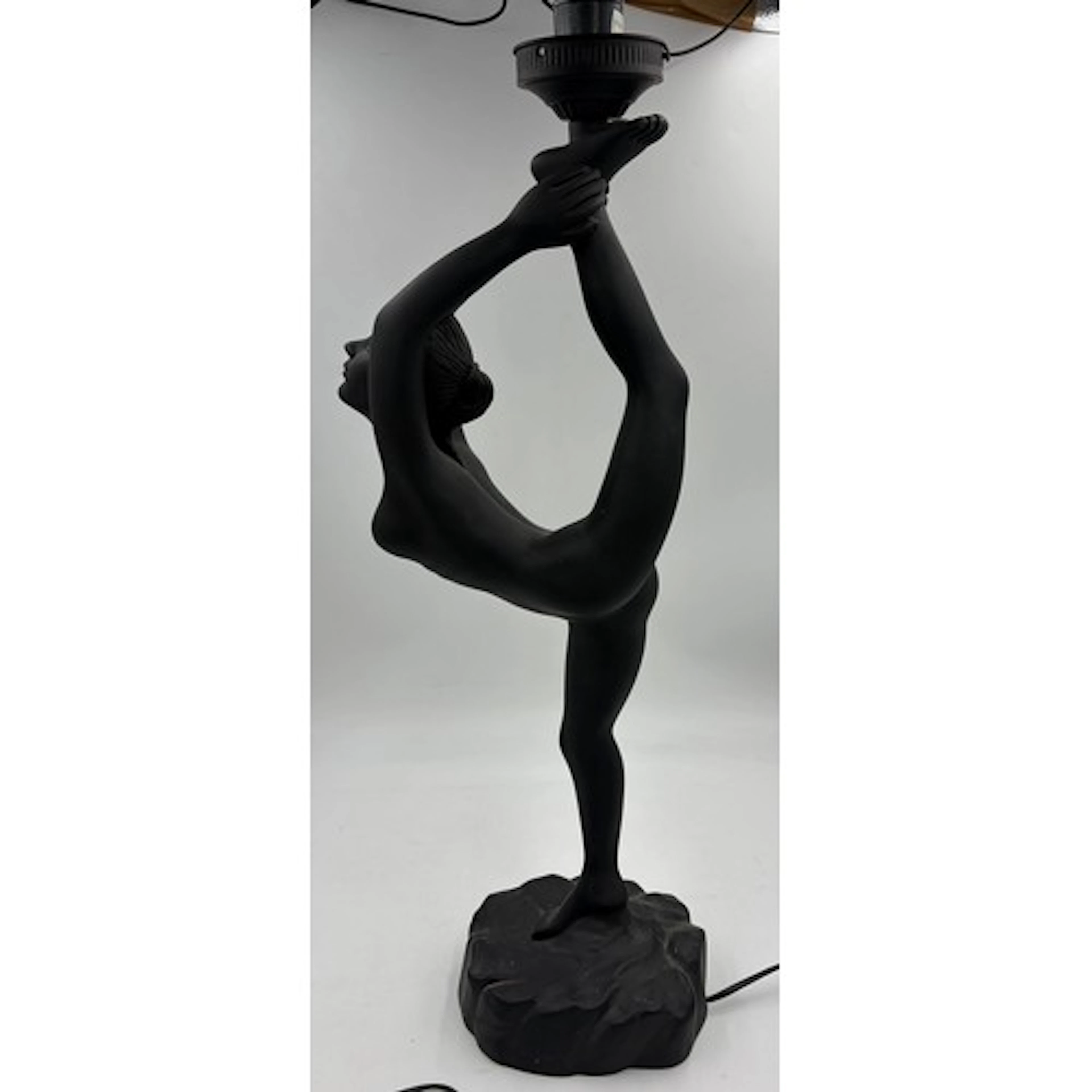 Art Deco style table lamp featuring a matte black female dan...