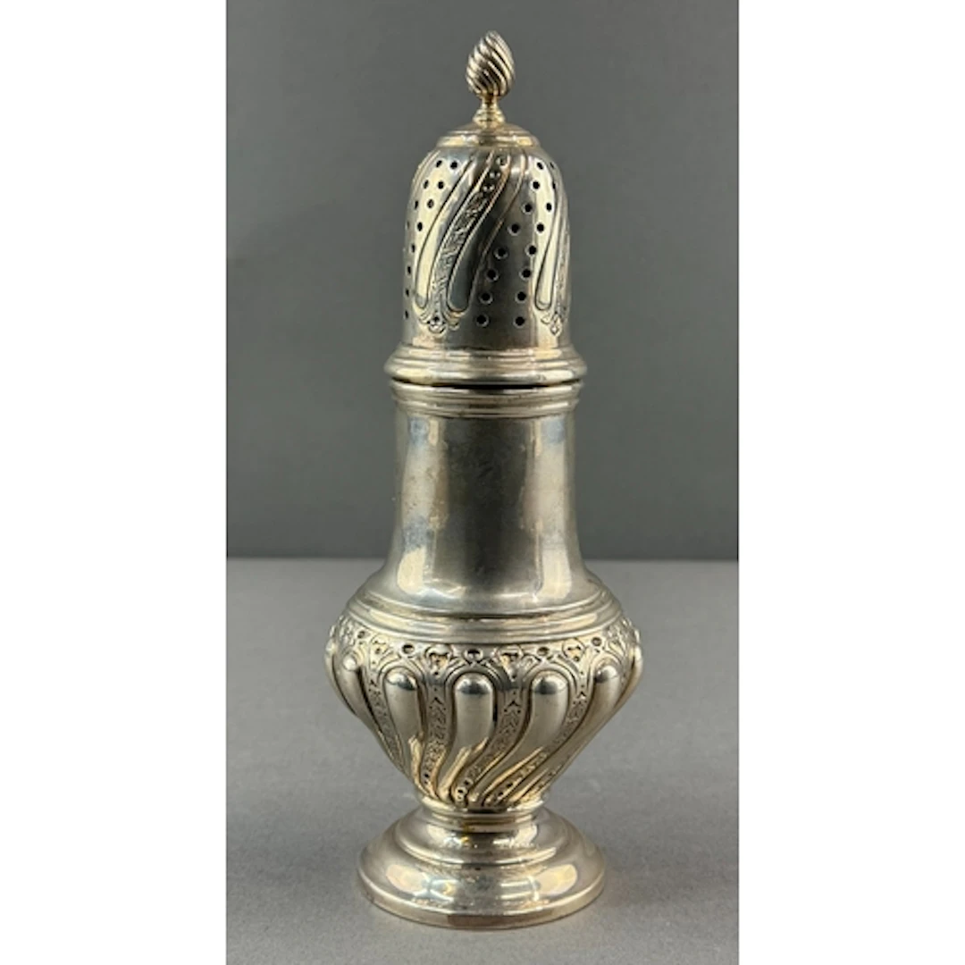 Silver: a baluster sugar caster by Joseph Rodgers & Sons...