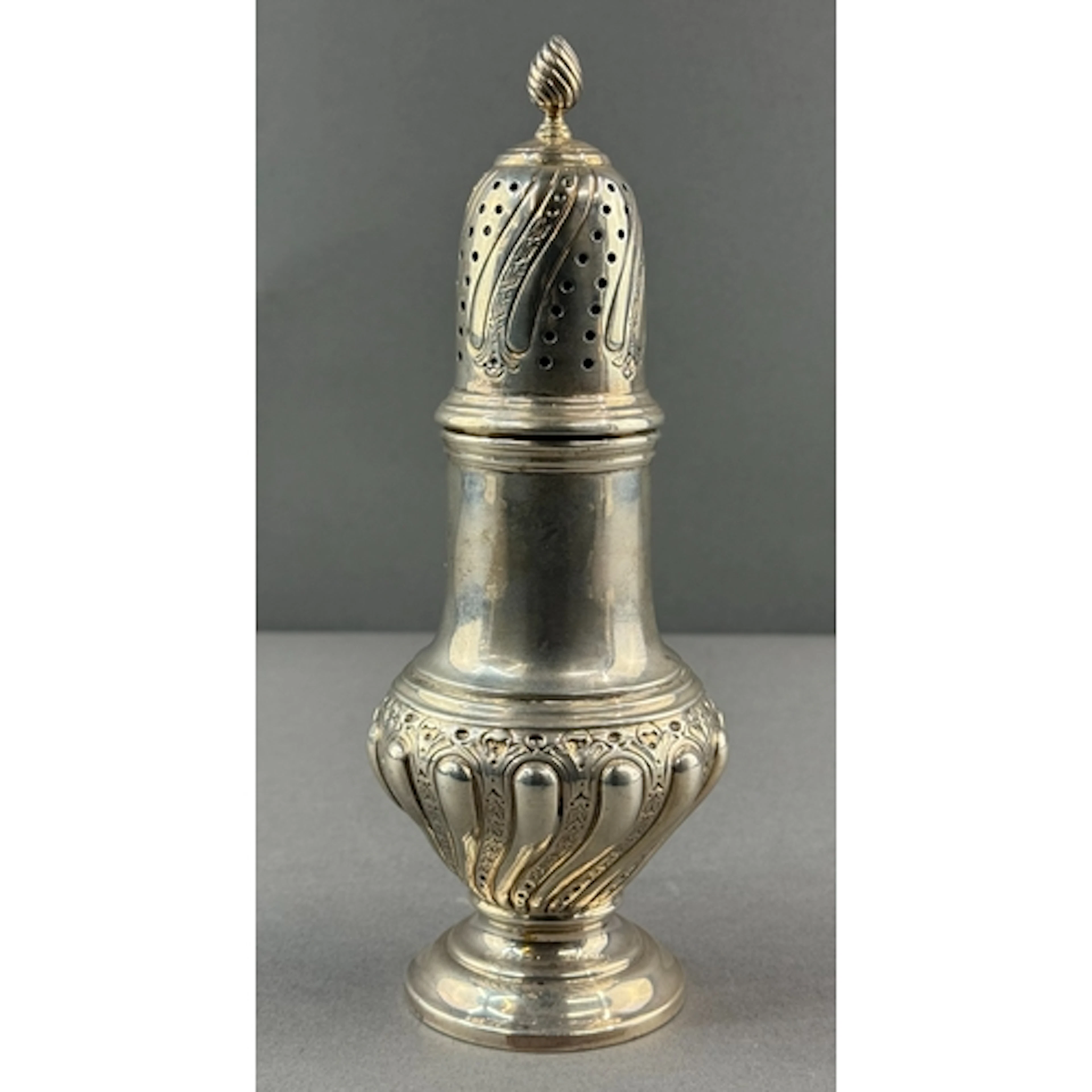 Silver: a baluster sugar caster by Joseph Rodgers & Sons...