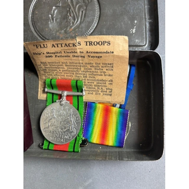 A Defence medal together with a Kings medal.