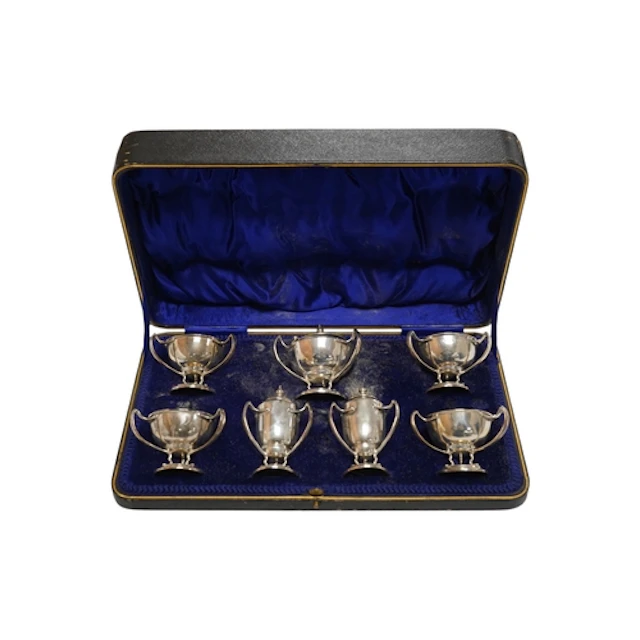 A cased Edwardian Art Nouveau silver seven piece condiment s...