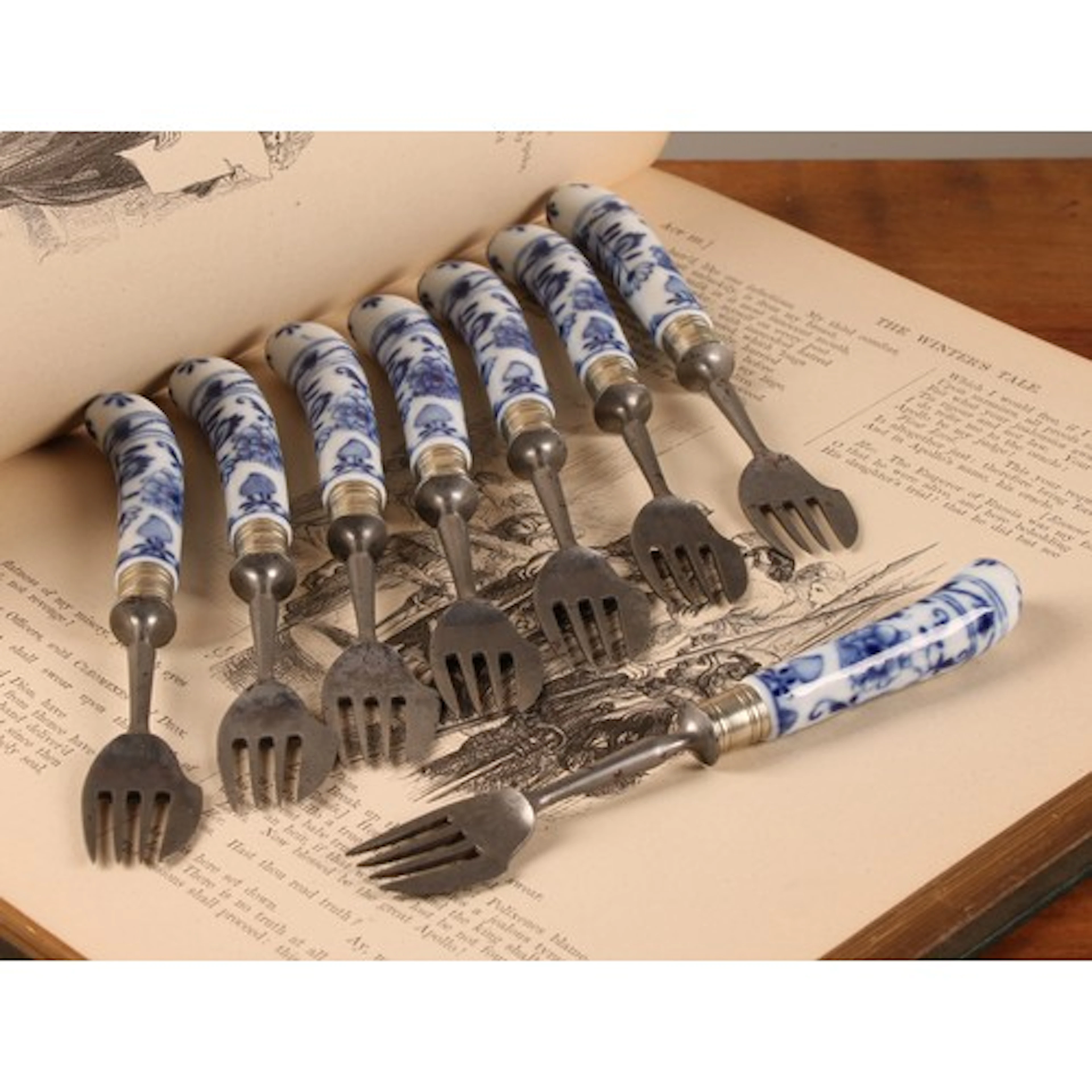A set of eight German porcelain mounted pistol grip forks, t...