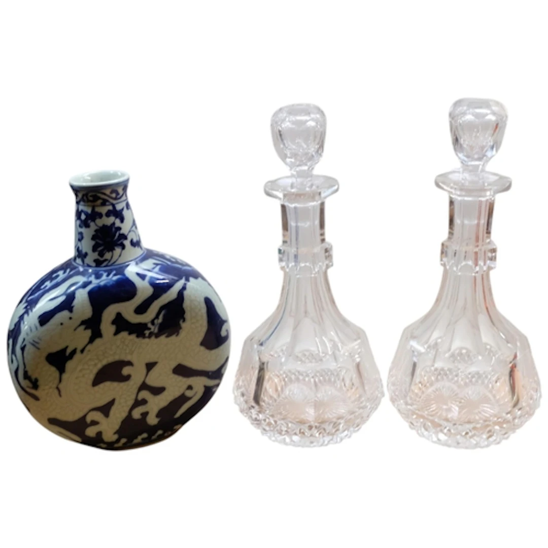 An Oriental moon flask, and a pair of cut-crystal decanters ...