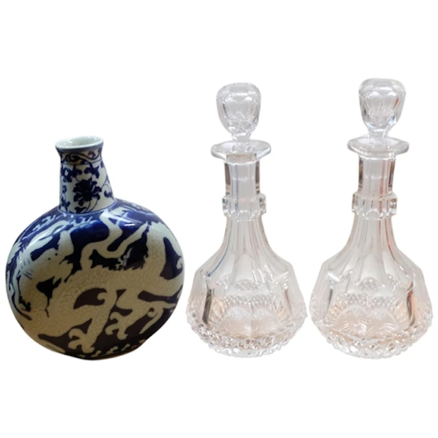 An Oriental moon flask, and a pair of cut-crystal decanters ...