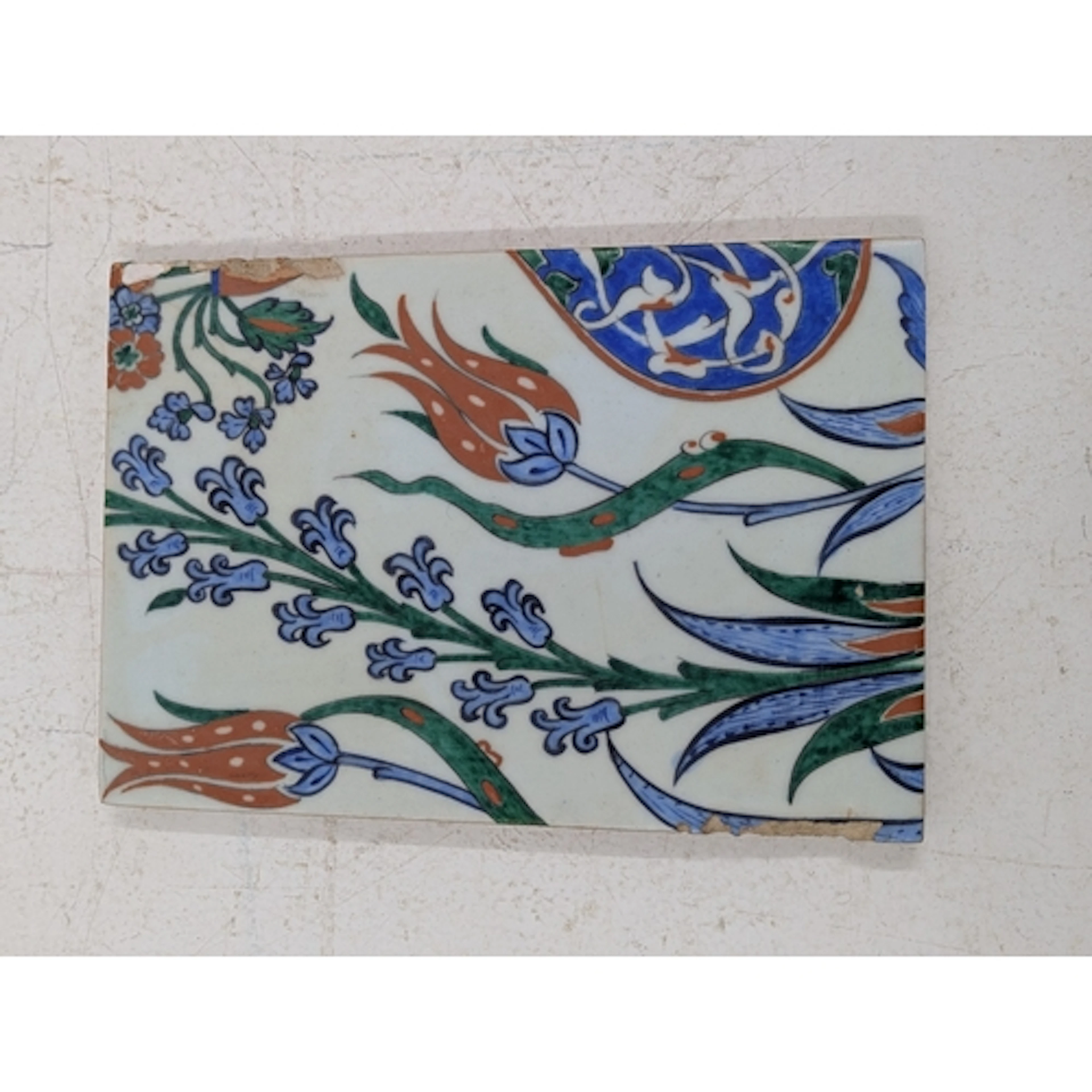 An Iznic ceramic tile, decorated with floral motifs, tulips ...