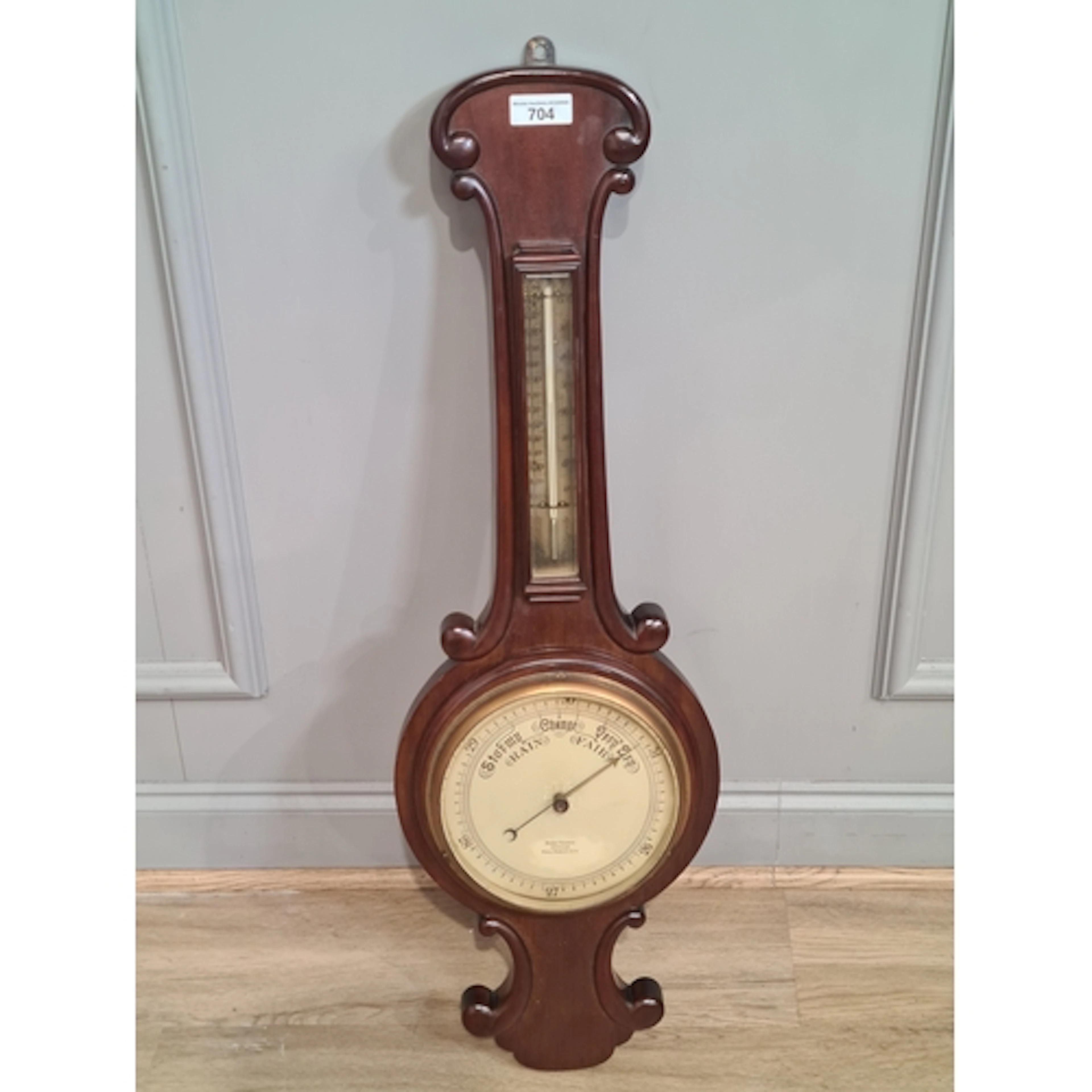 A mahogany framed Wheel Barometer the face bearing the name ...