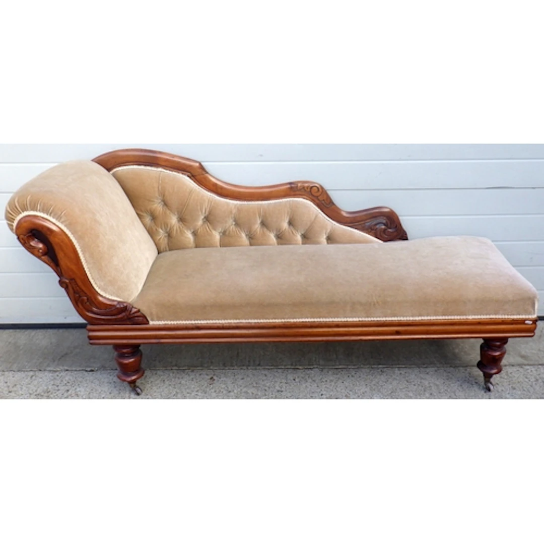 A beige upholstered chaise longue
