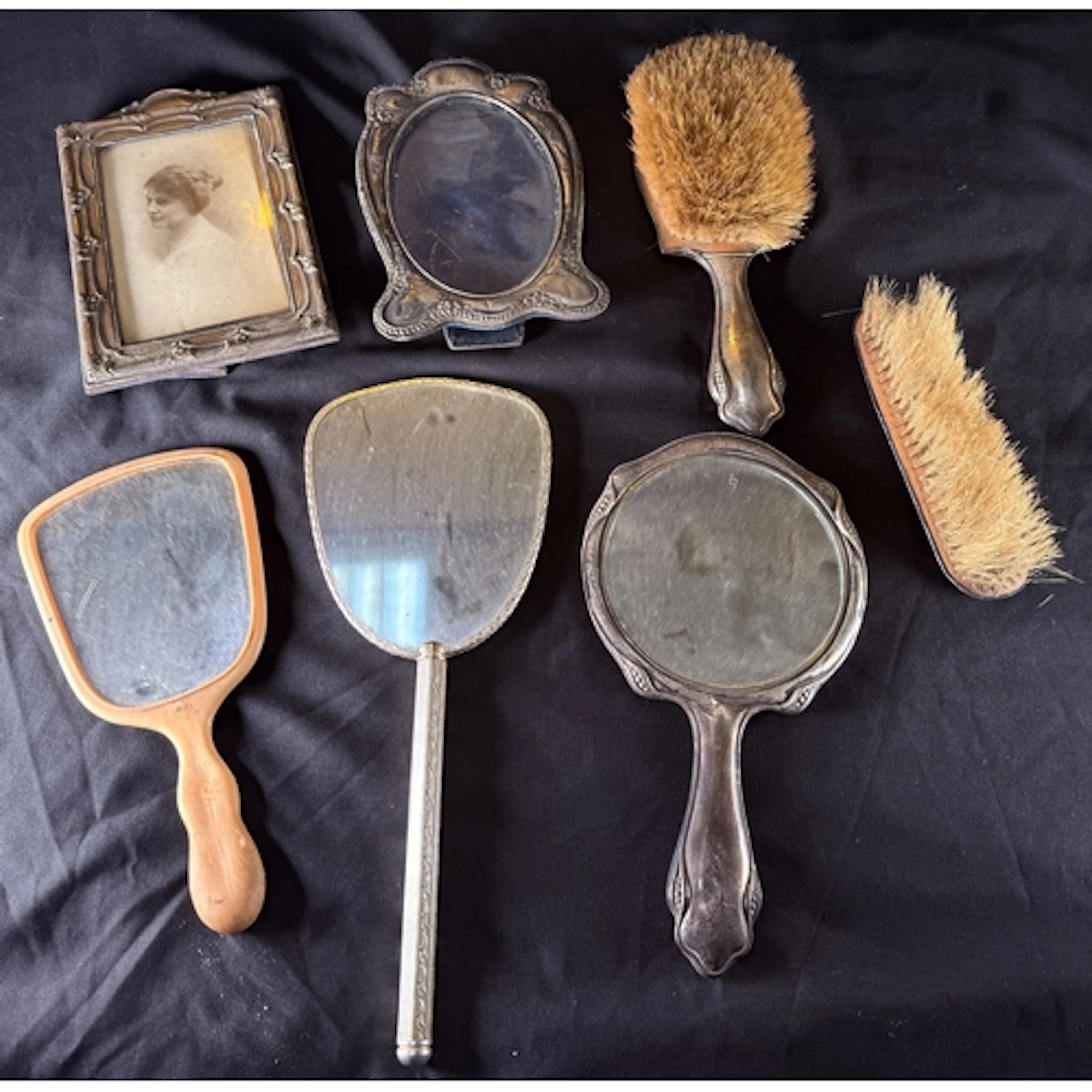 Two hall marked silver picture frames, and a silver backed t...