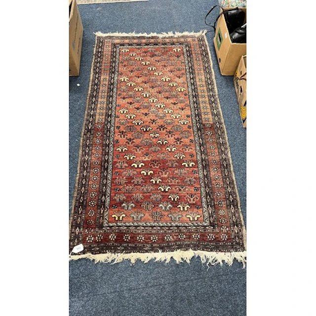 Eastern red ground rug, the field decorated with stylised fl...