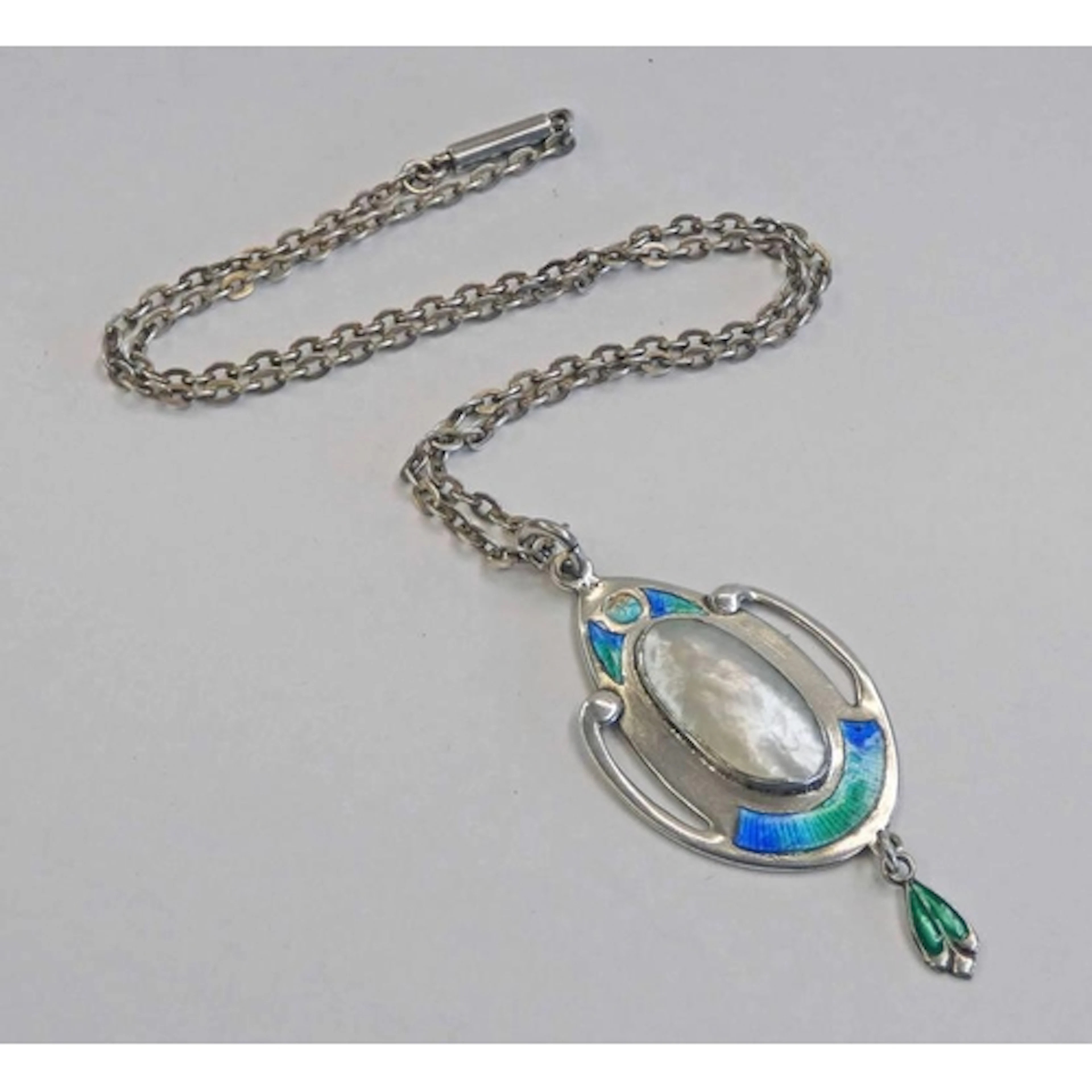 ARTS & CRAFTS SILVER MOTHER OF PEARL AND ENAMEL PENDANT. THE...