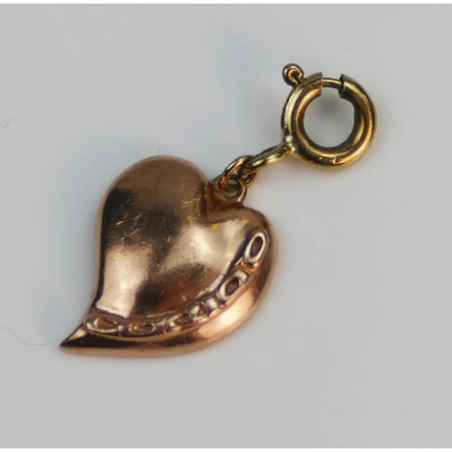 Clogau - a 9ct rose gold heart charm on a 9ct yellow gold bo...