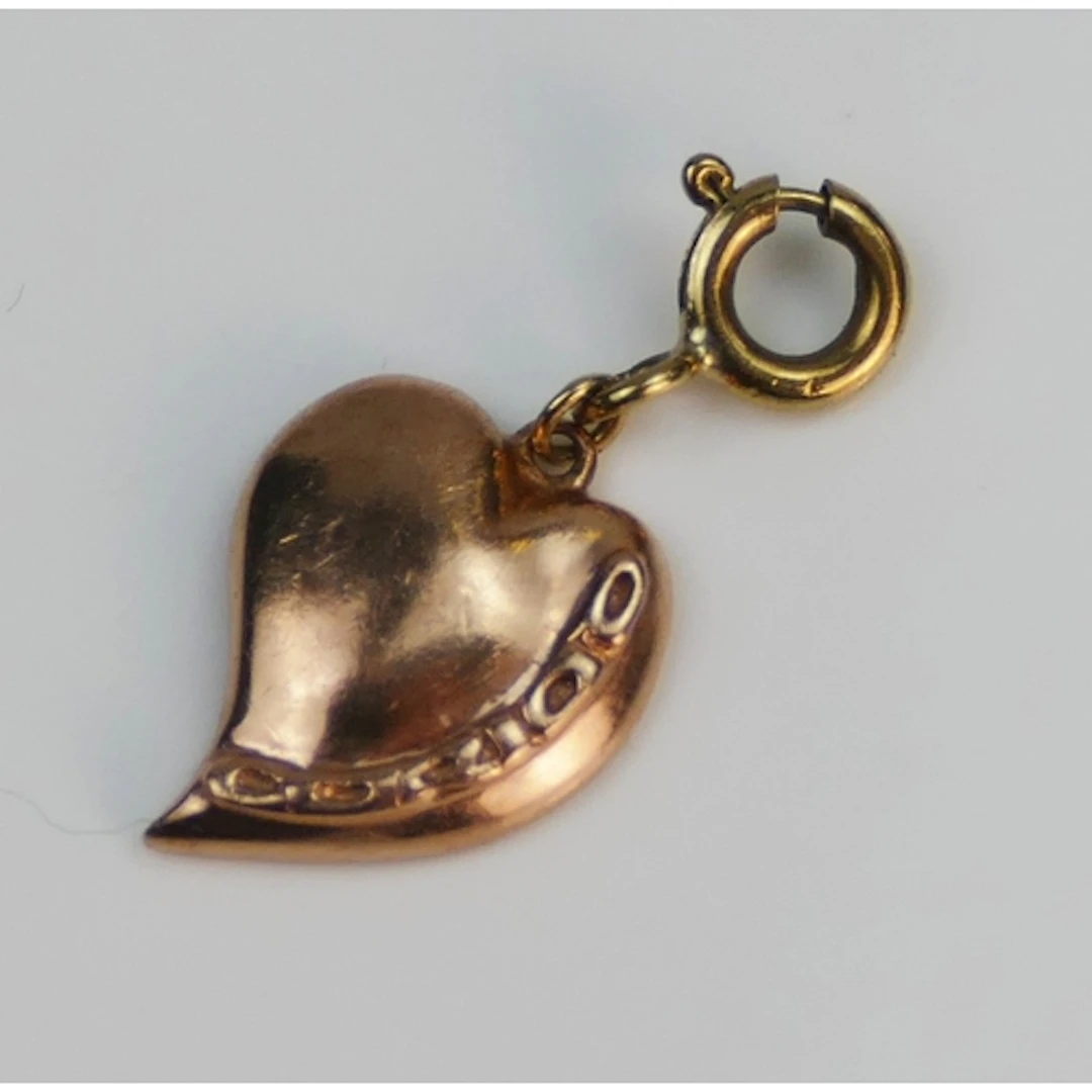 Clogau - a 9ct rose gold heart charm on a 9ct yellow gold bo...
