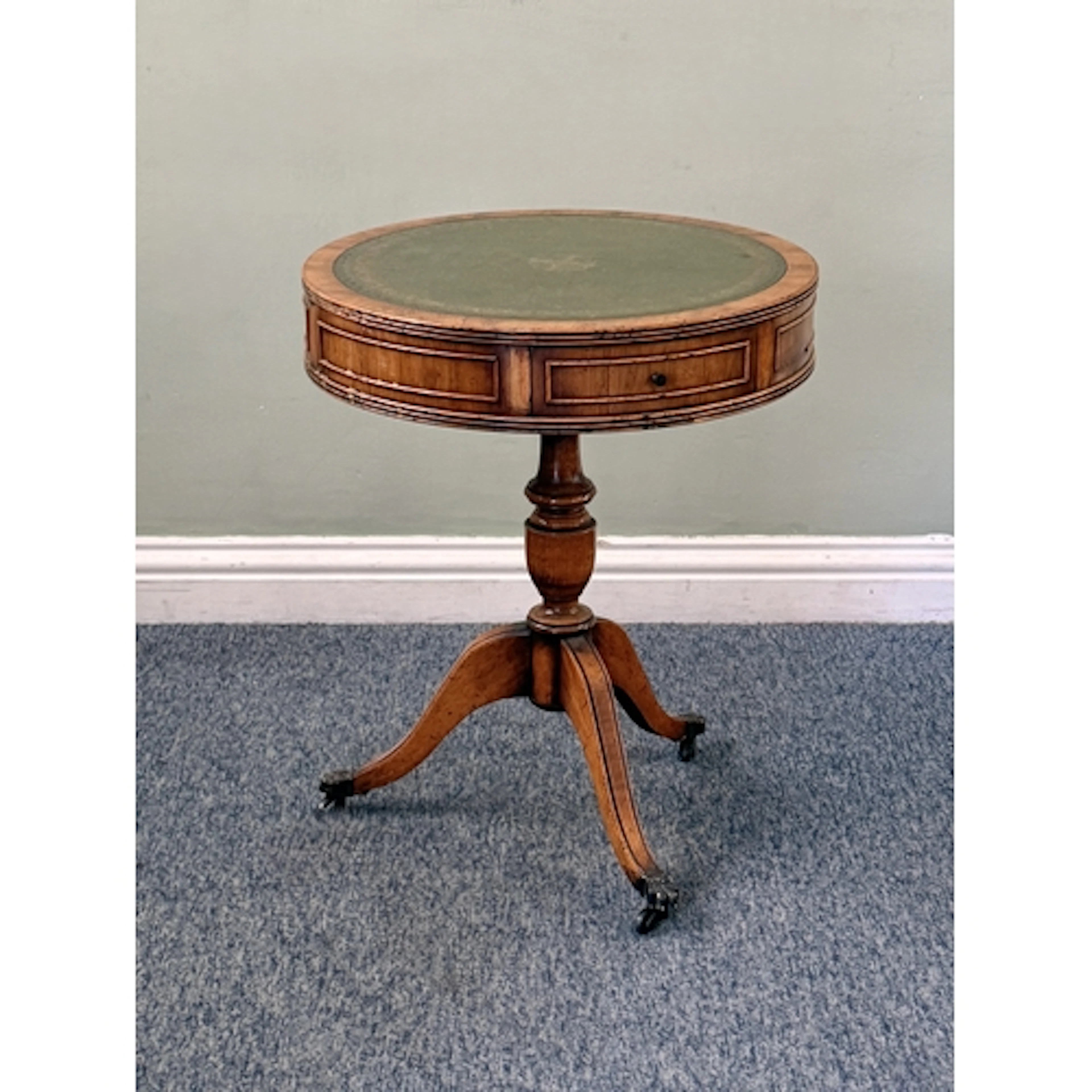 A small reproduction yew veneered and gilt tooled leather dr...