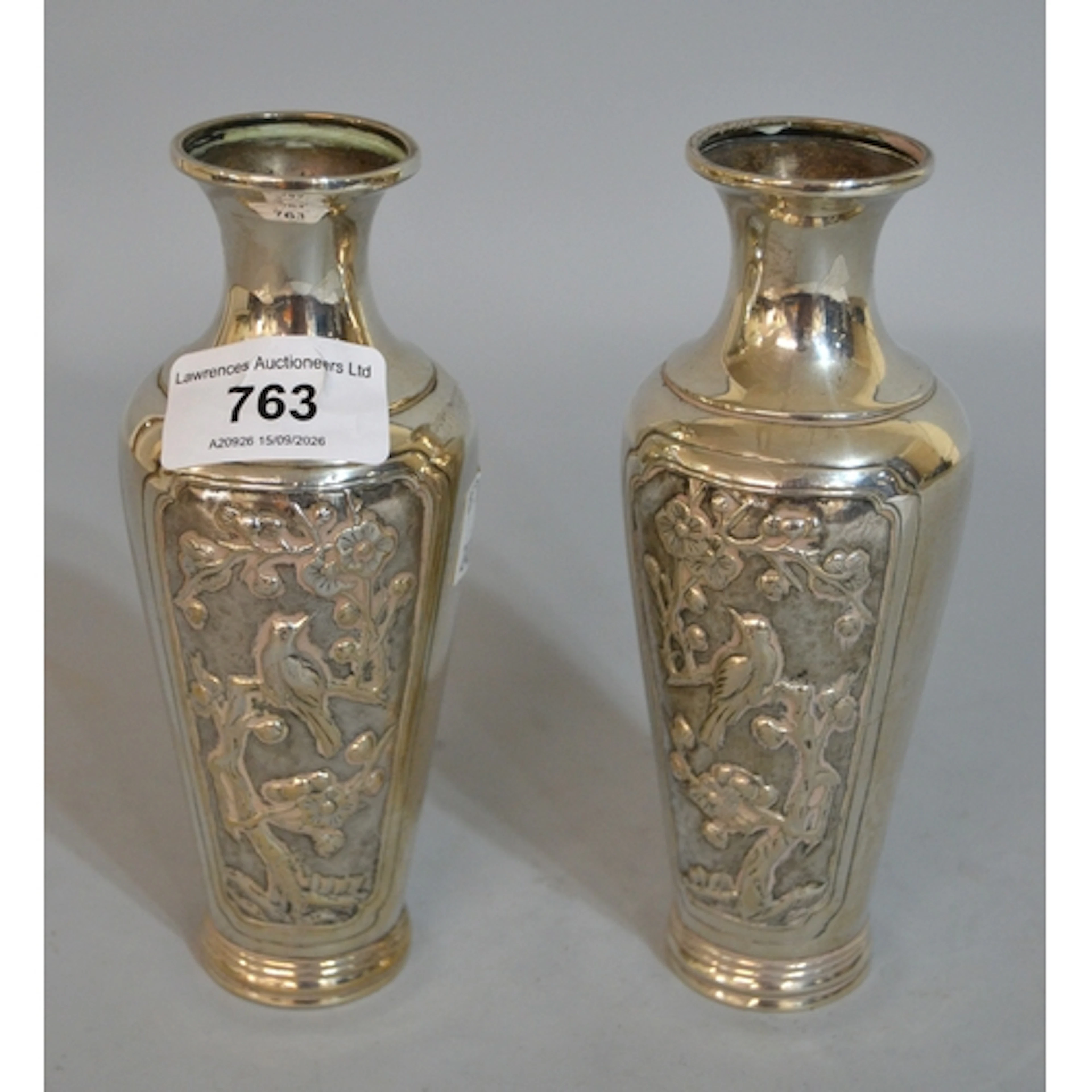 Pair of Chinese silver vases of tapering form relief cast wi...