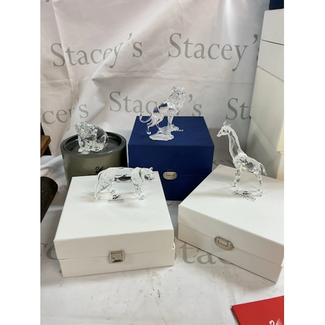 A collection of Four Swarovski crystal animal figures