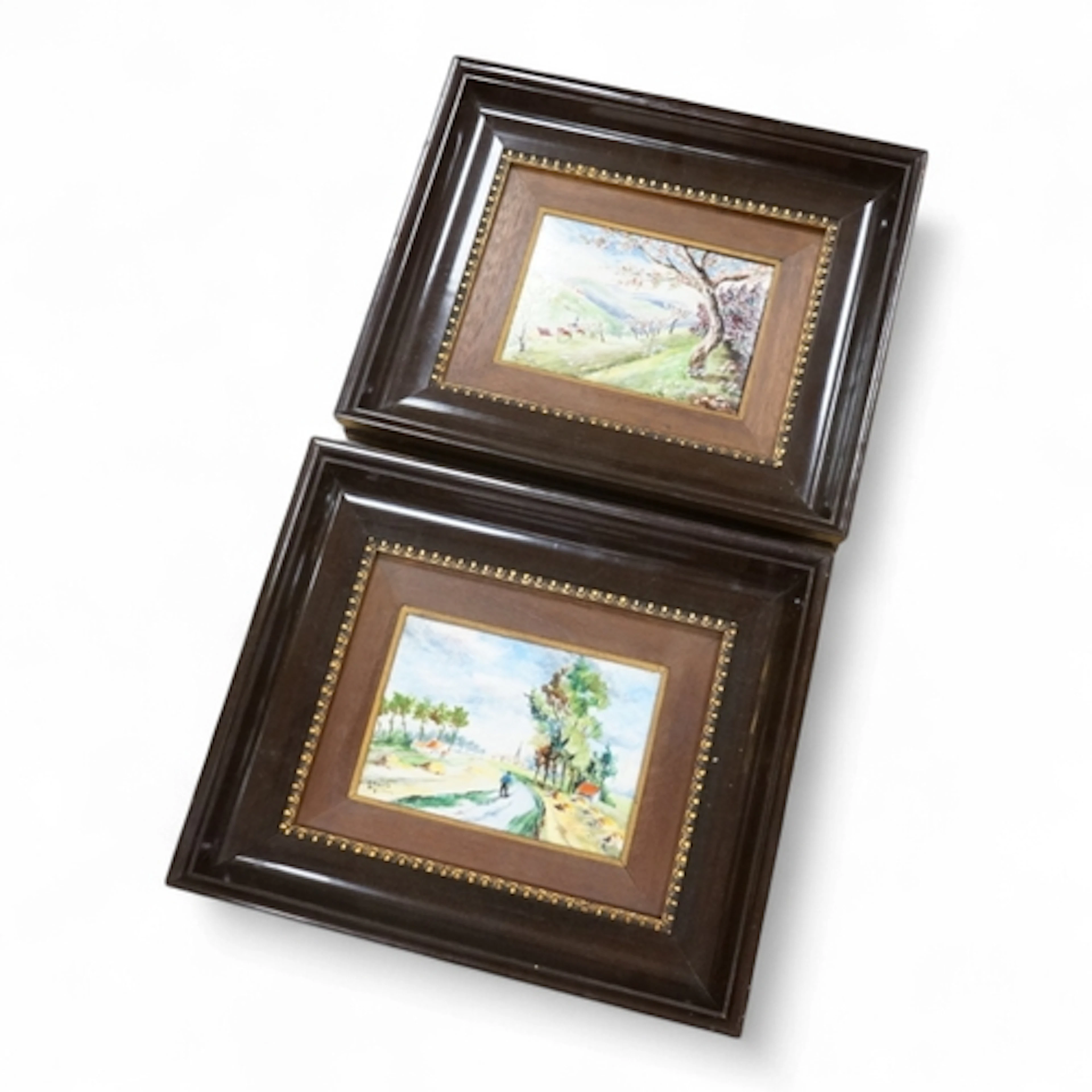 A pair of Limoges porcelain plaques depicting landscapes, si...
