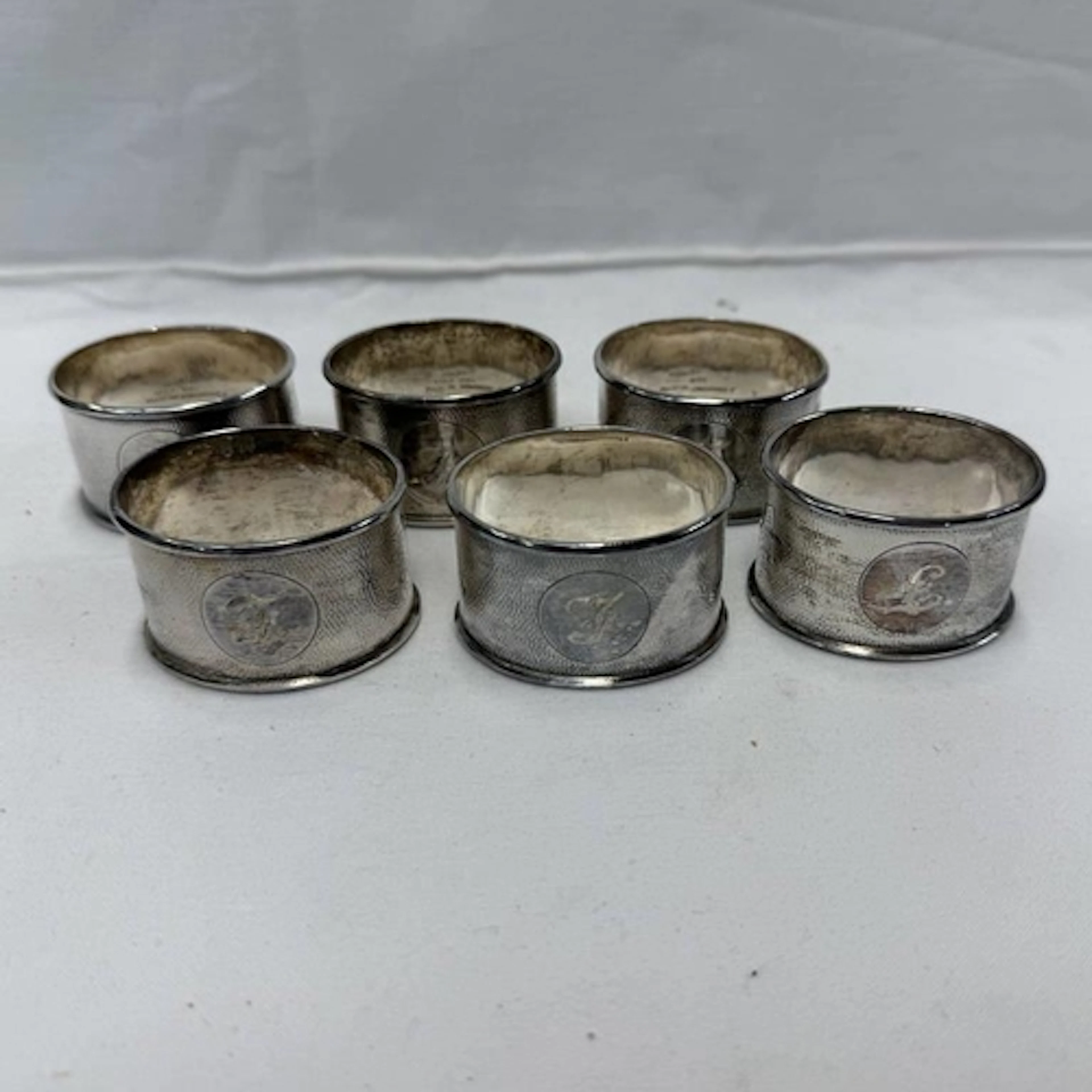 A SET OF 6 HONG KONG STERLING SILVER NAPKIN RINGS . 217G