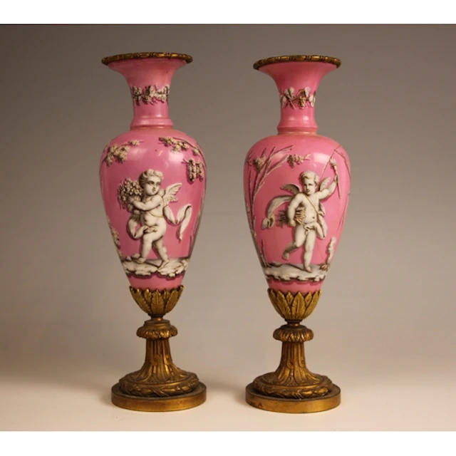A pair of ormolu mounted pink porcelain stem vases in the ma...