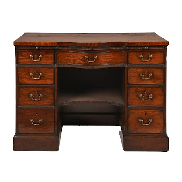 A George III serpentine centred mahogany dressing table, fit...