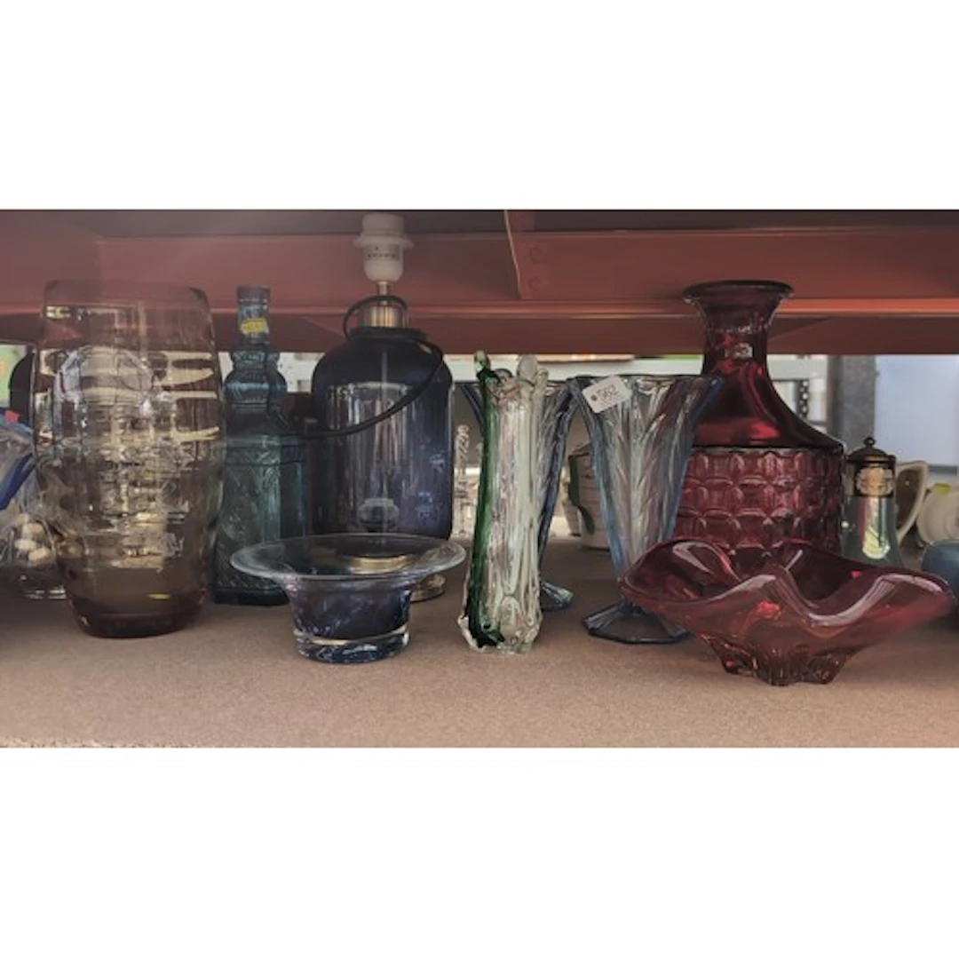 A quantity of coloured glass vases, bowls and a lamp base, i...