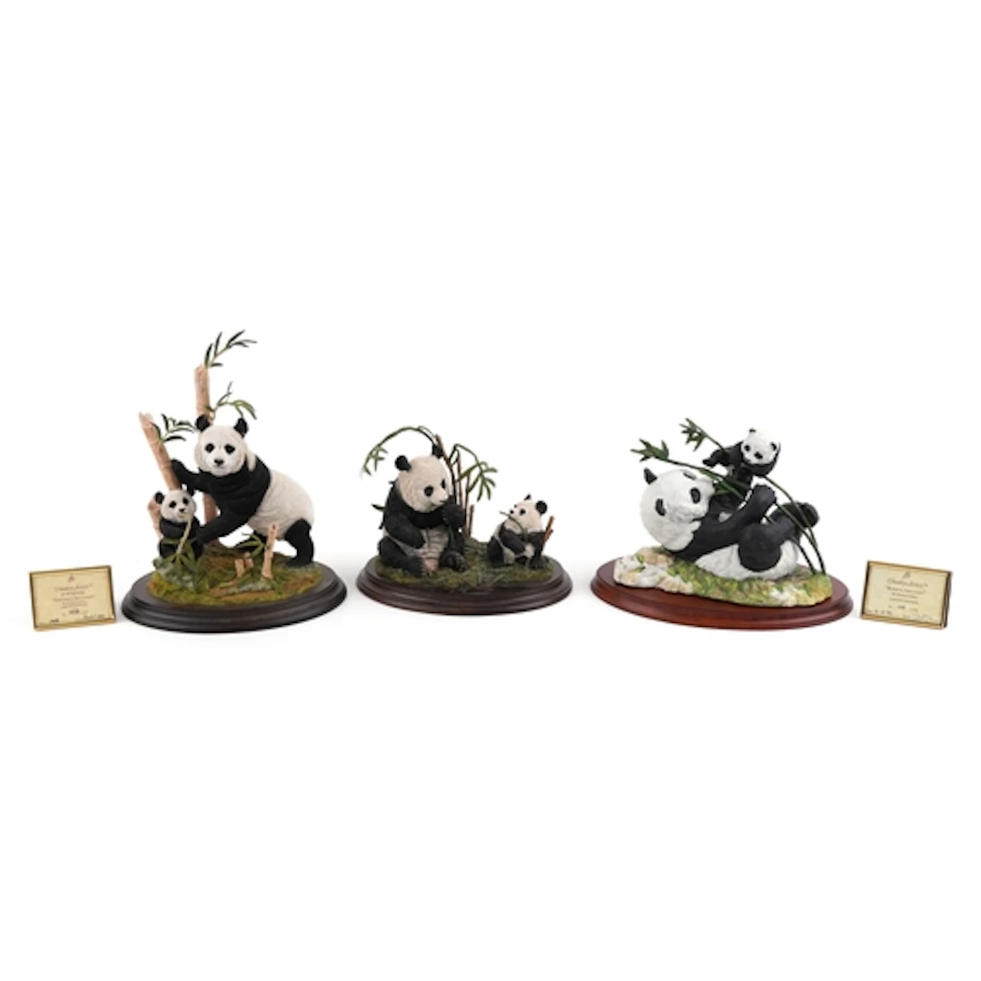 Three decorative panda figure groups comprising Sheltered Se...